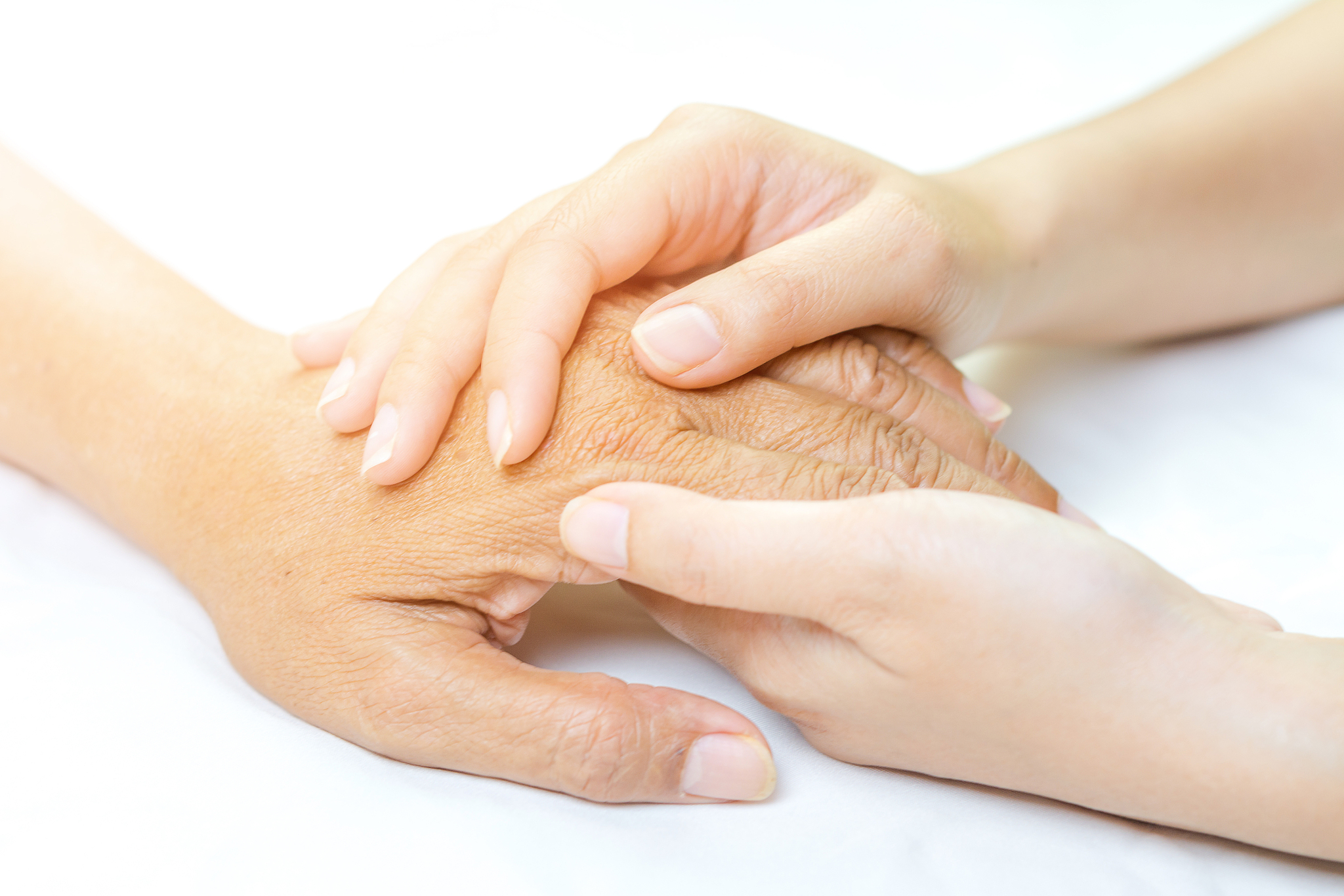 asian senior and asian young holding hands.