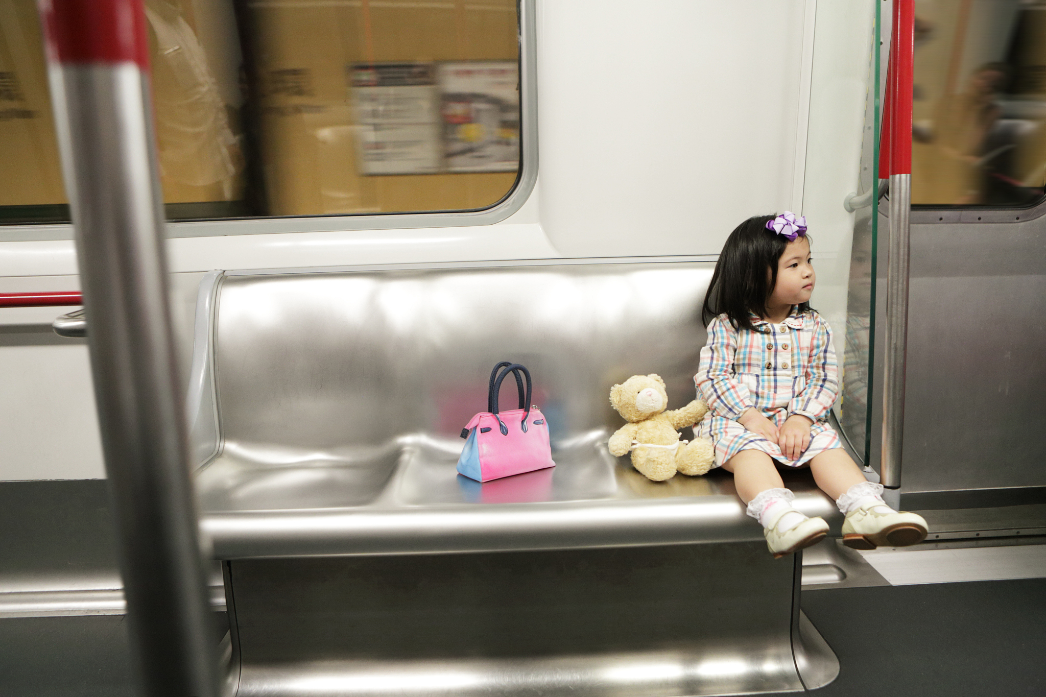 young girl sat on train alone