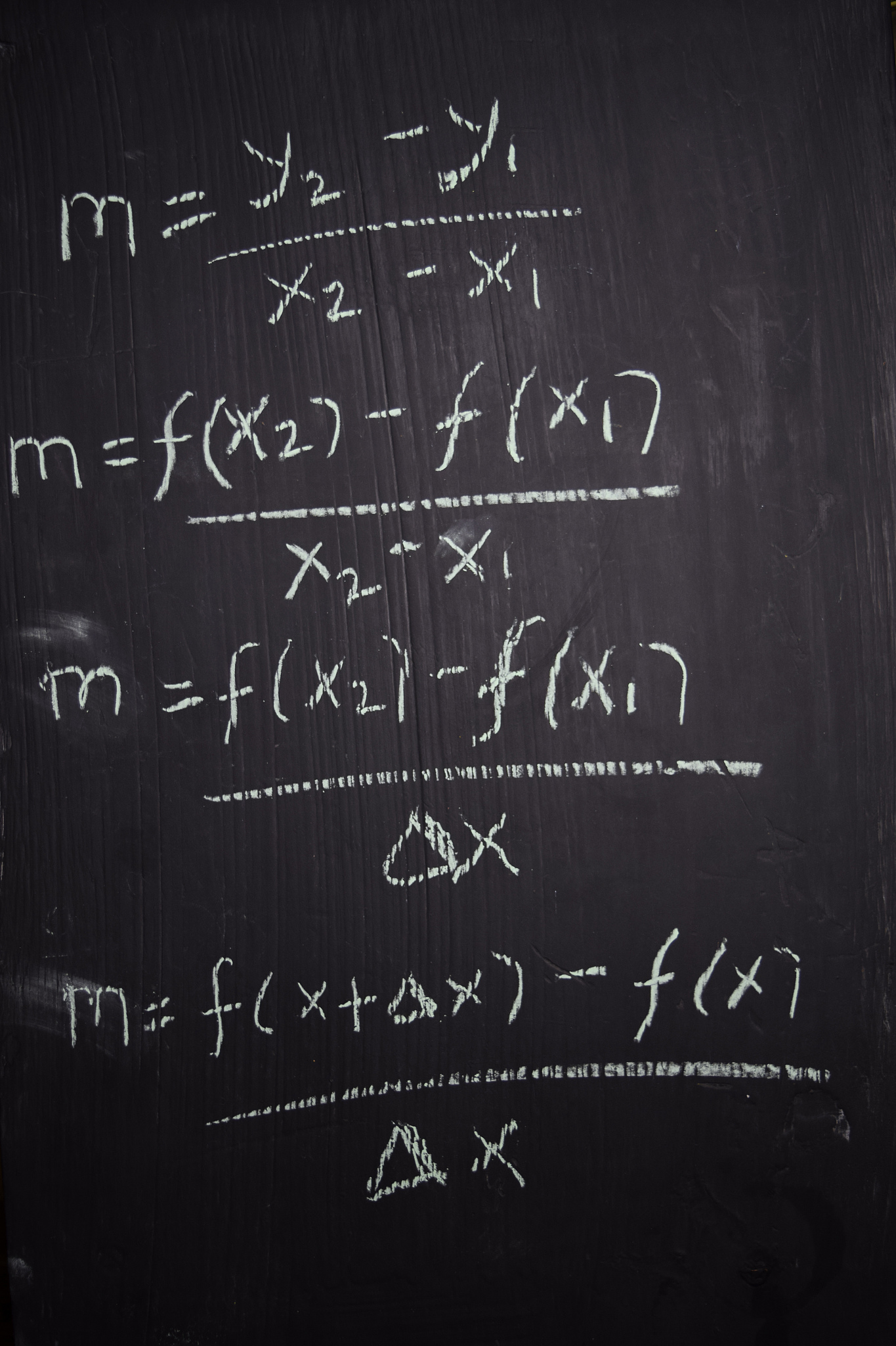 close up math formulas written on a blackboard. education concep