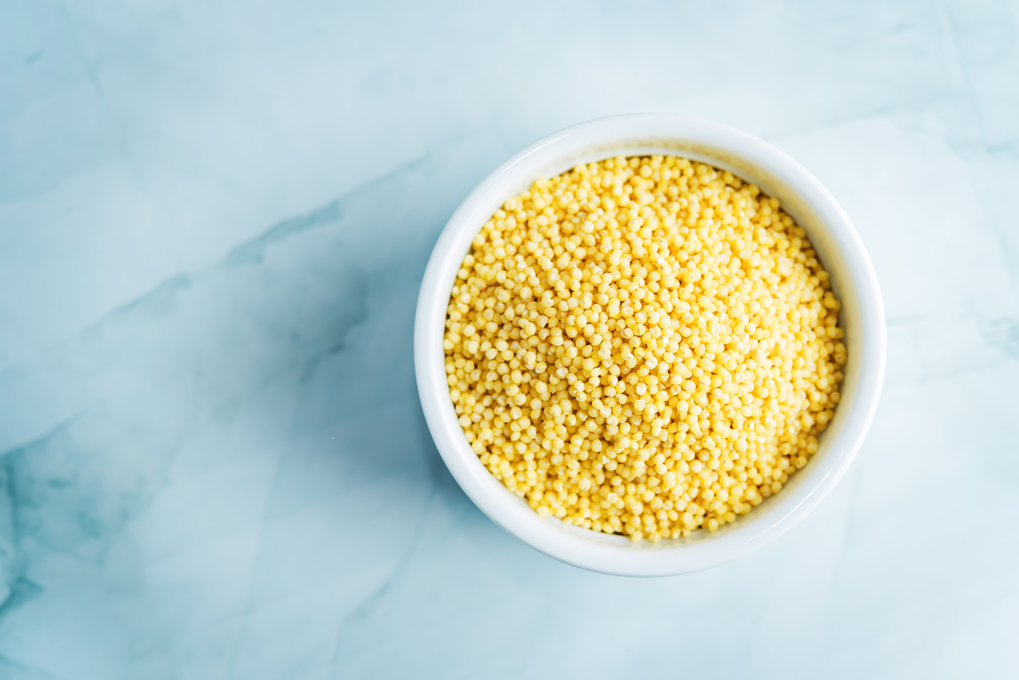 dried millet porridge in the white bowl
