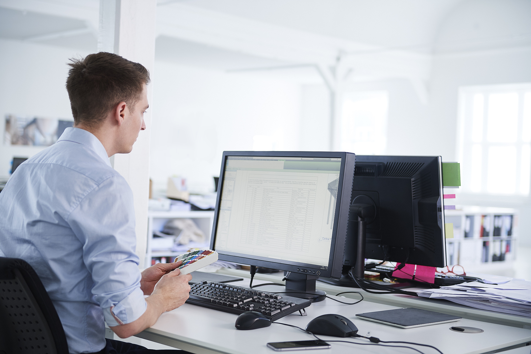 man in office using computer