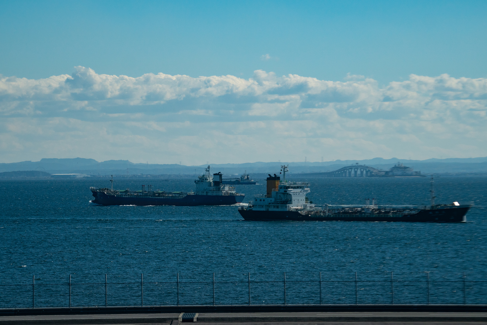 tokyo bay aqua line and tankers sailing on tokyo bay daytime aer