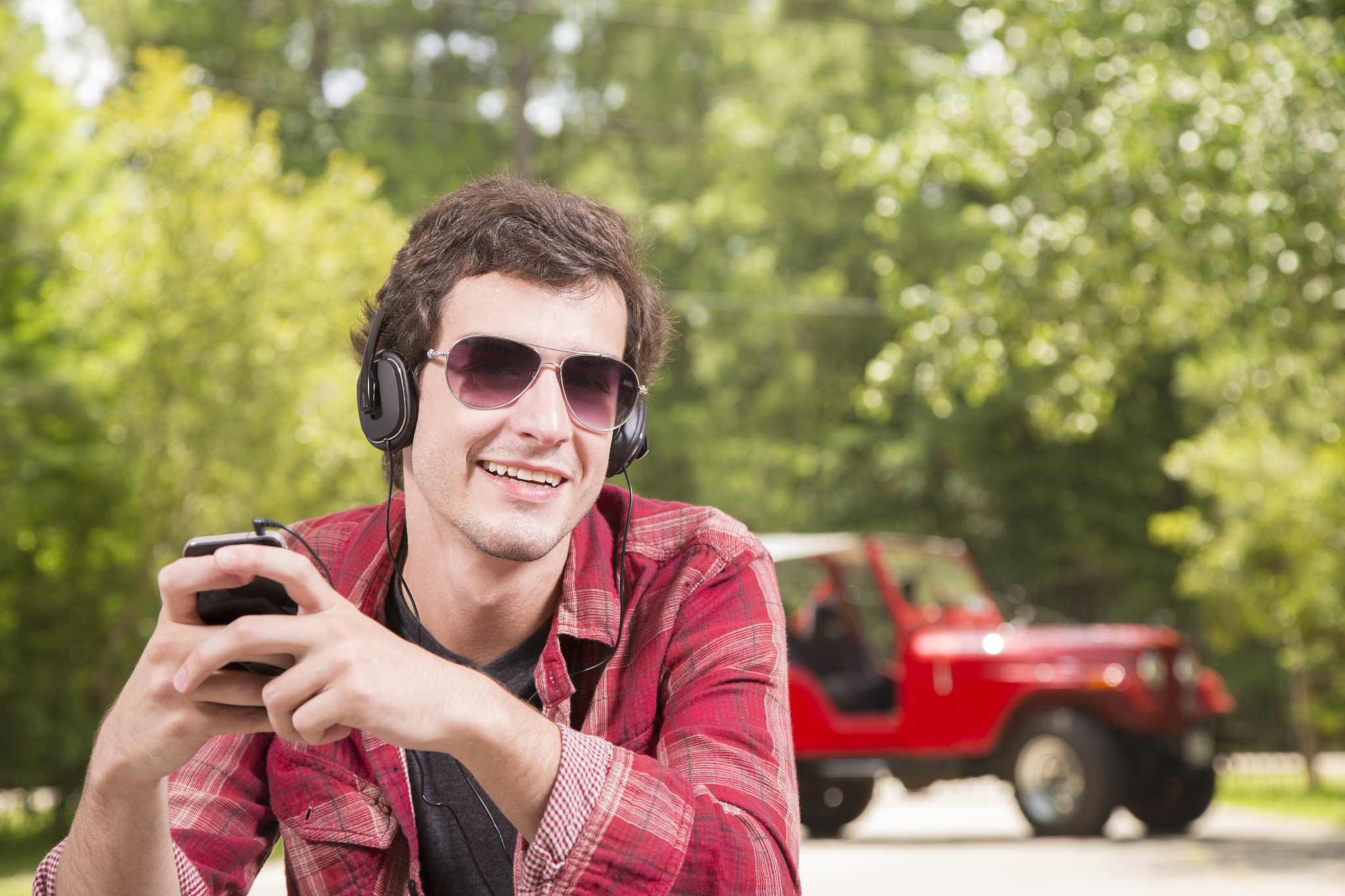 technology:  young adult wearing headphones listening to music.