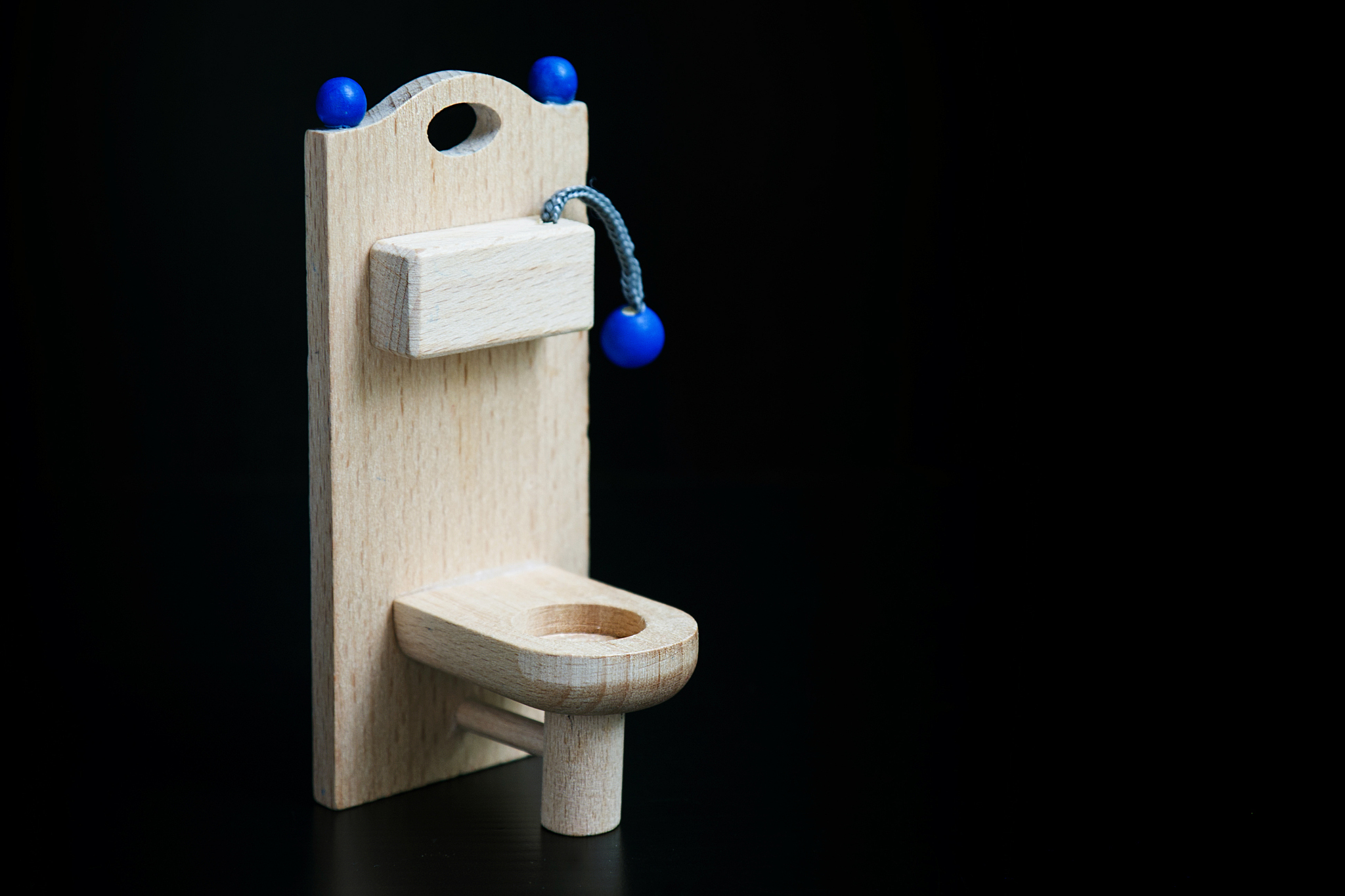 wooden toy toilet on black