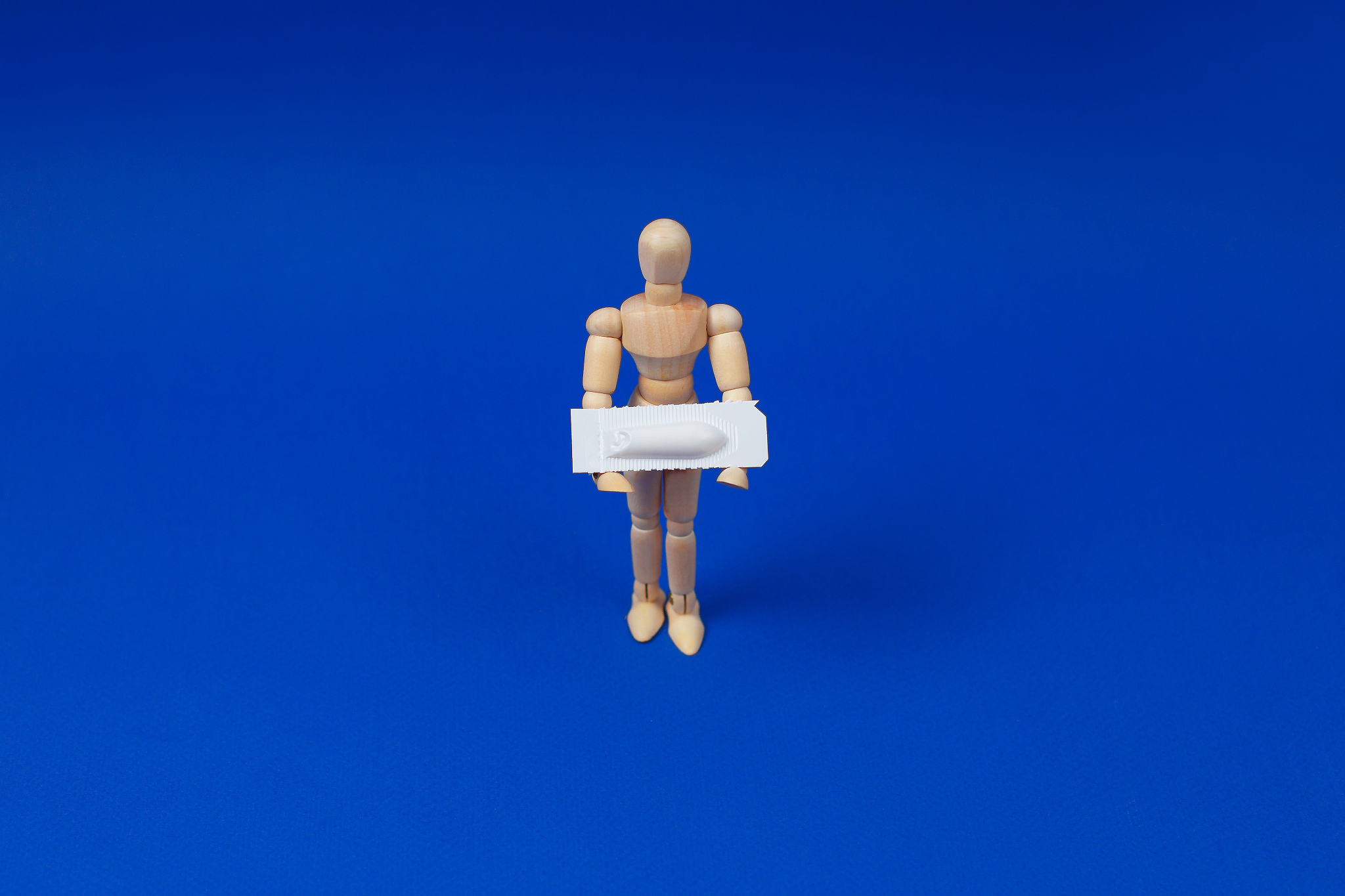 medical suppository, rectal or vaginal. isolated on blue backgro