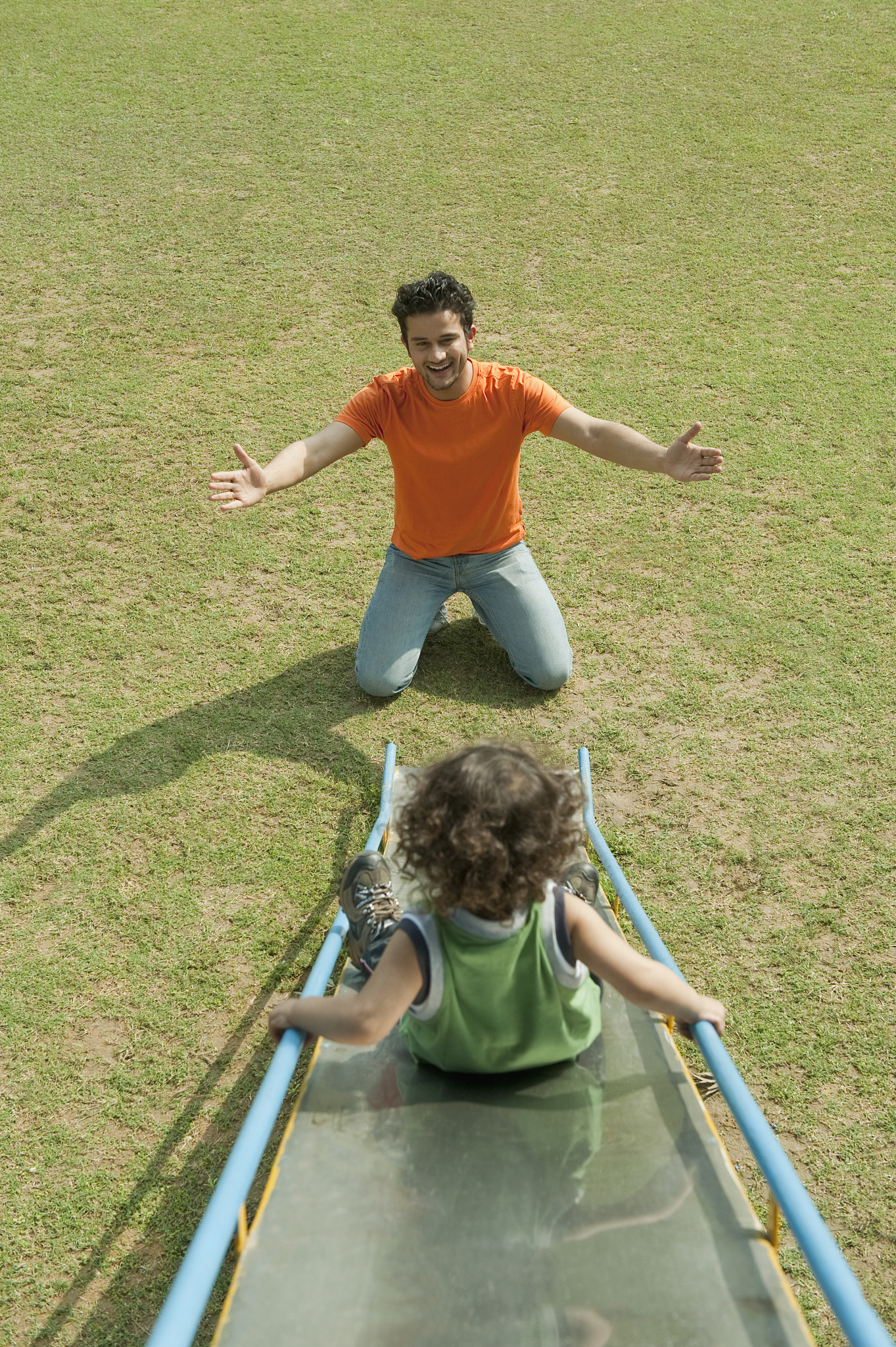man playing with his son in a garden