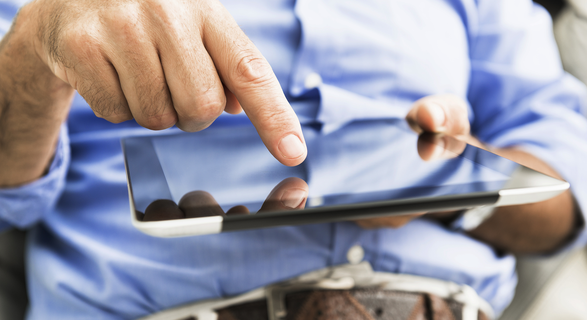 man typing on the digital tablet display