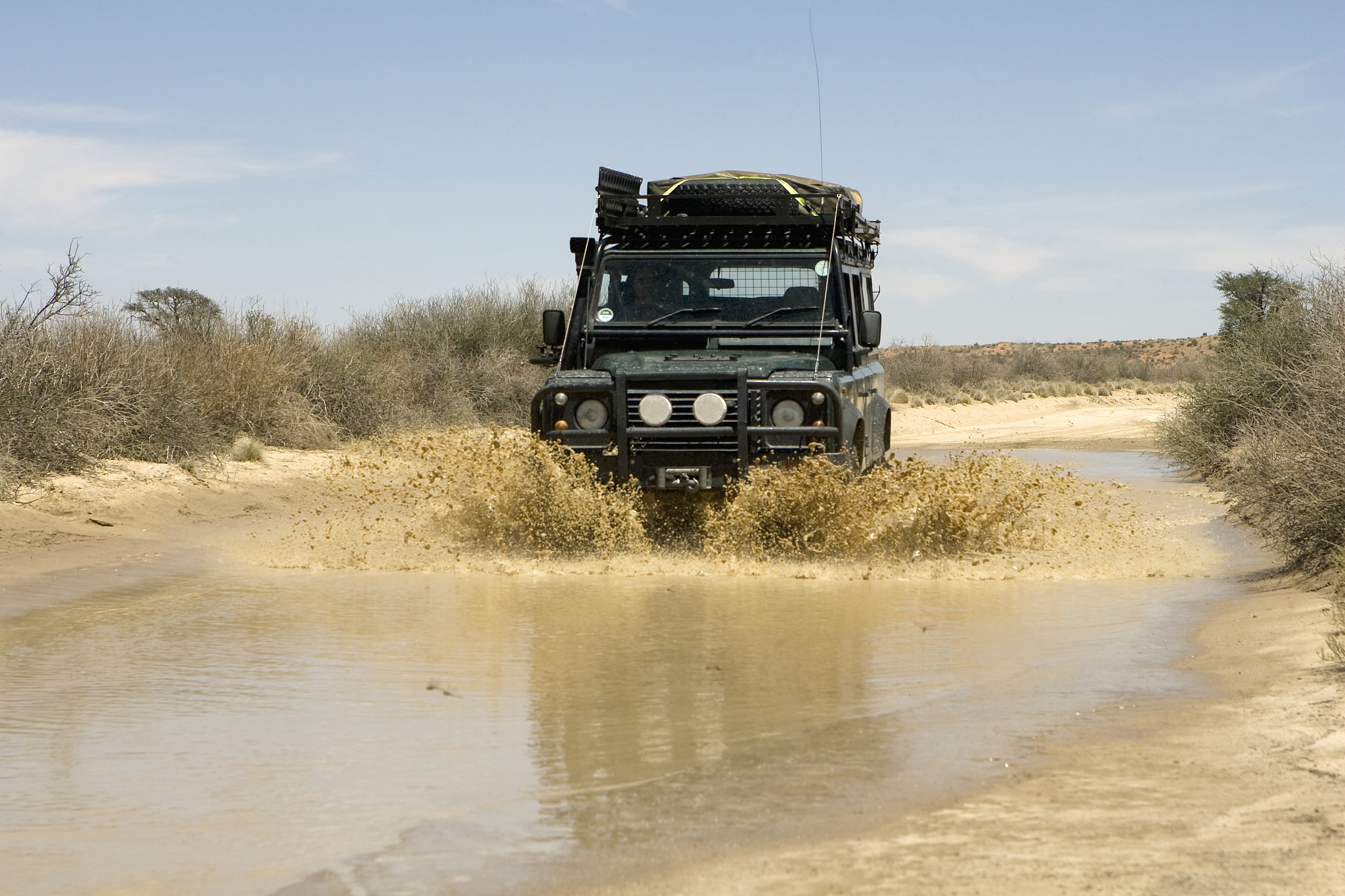 4x4 driving through water, kgalagadi trans-frontier park, south 