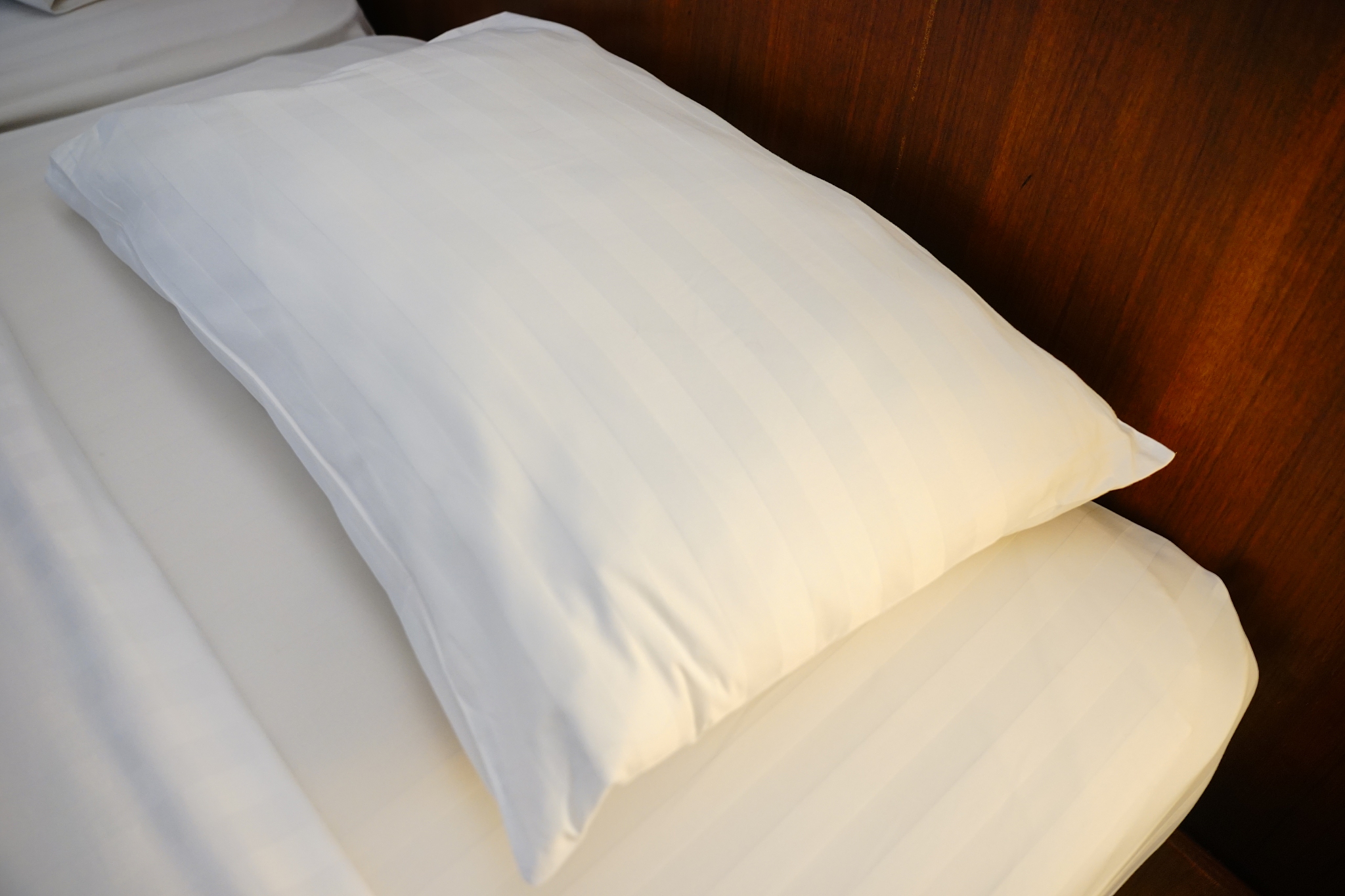 white pillow empty bed