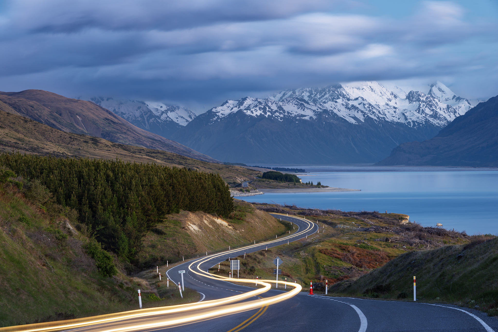 winding road (mount cook road) with traffic lights along lake pu