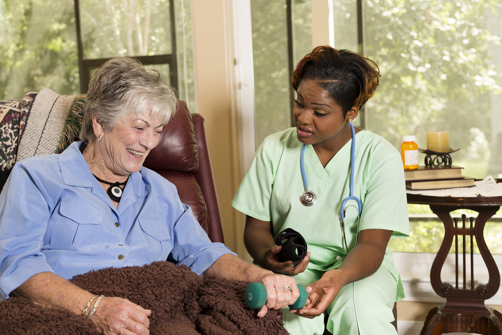 senior adult patient with home healthcare nurse. physical therap