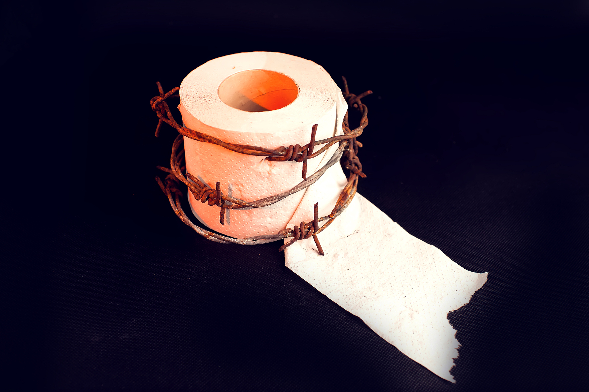 toilet paper with barbed wire around it. people, healthcare and 