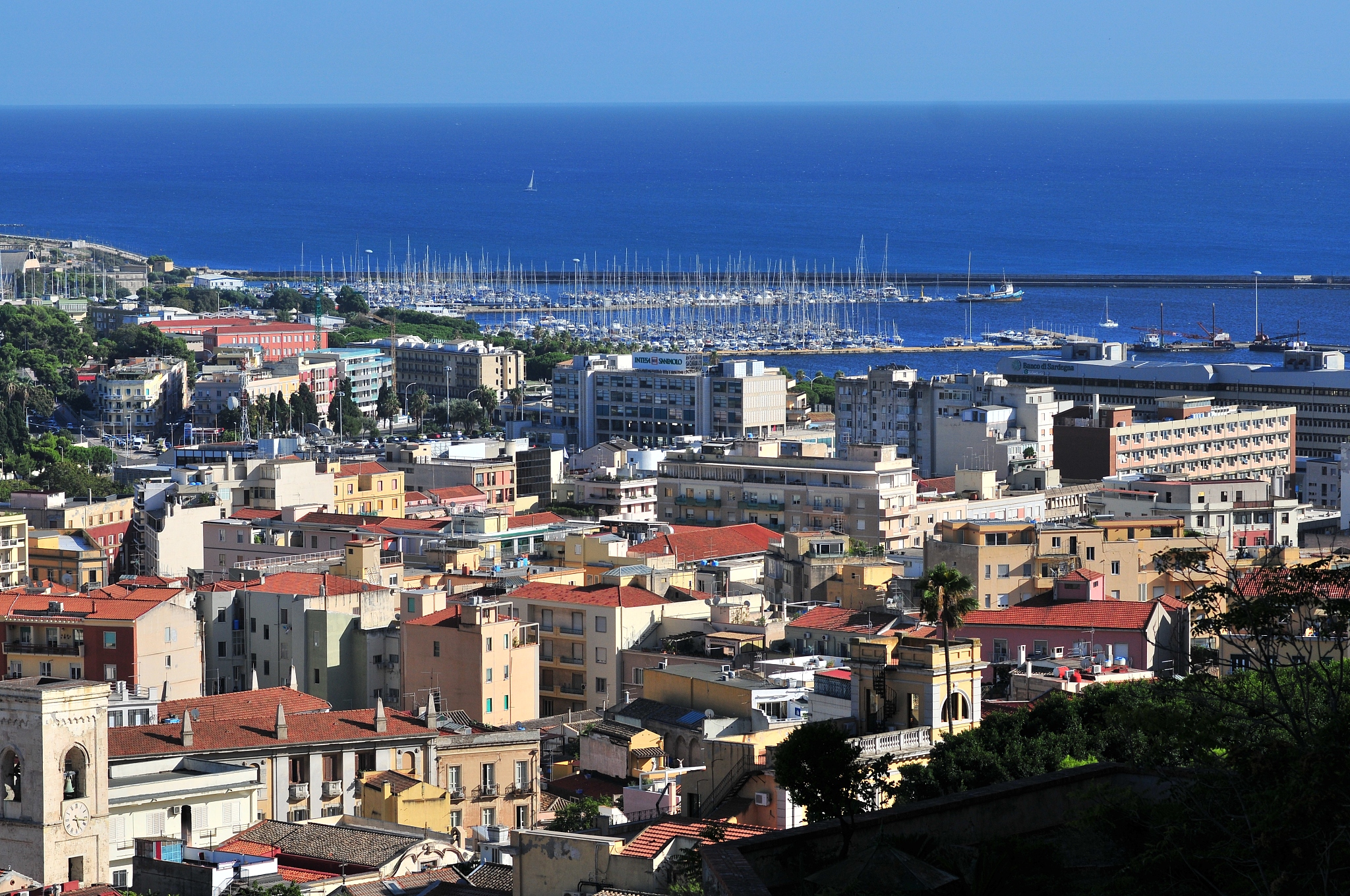 high angle view of townscape by sea against sky