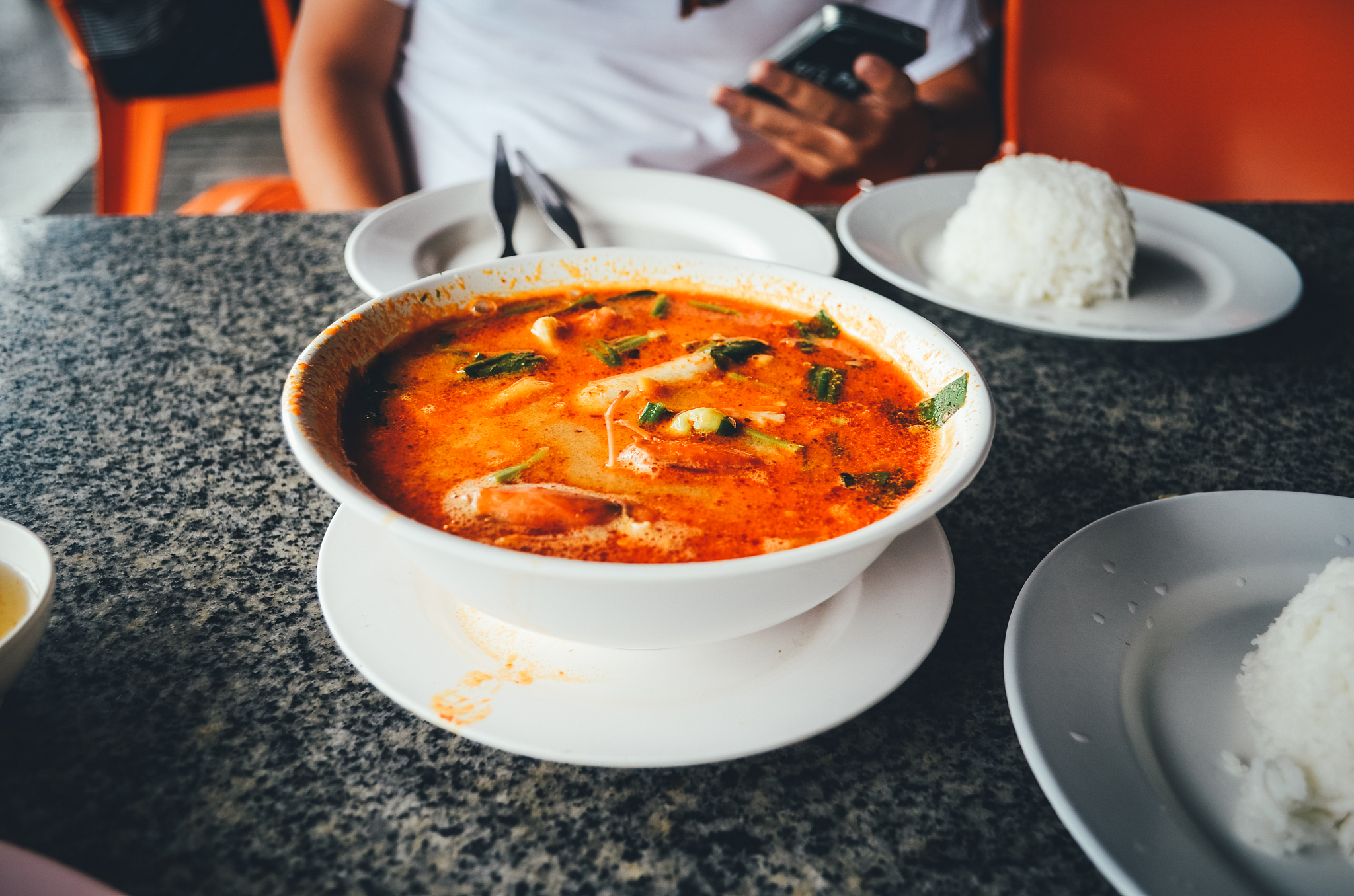 midsection of man sitting at table in restaurant
