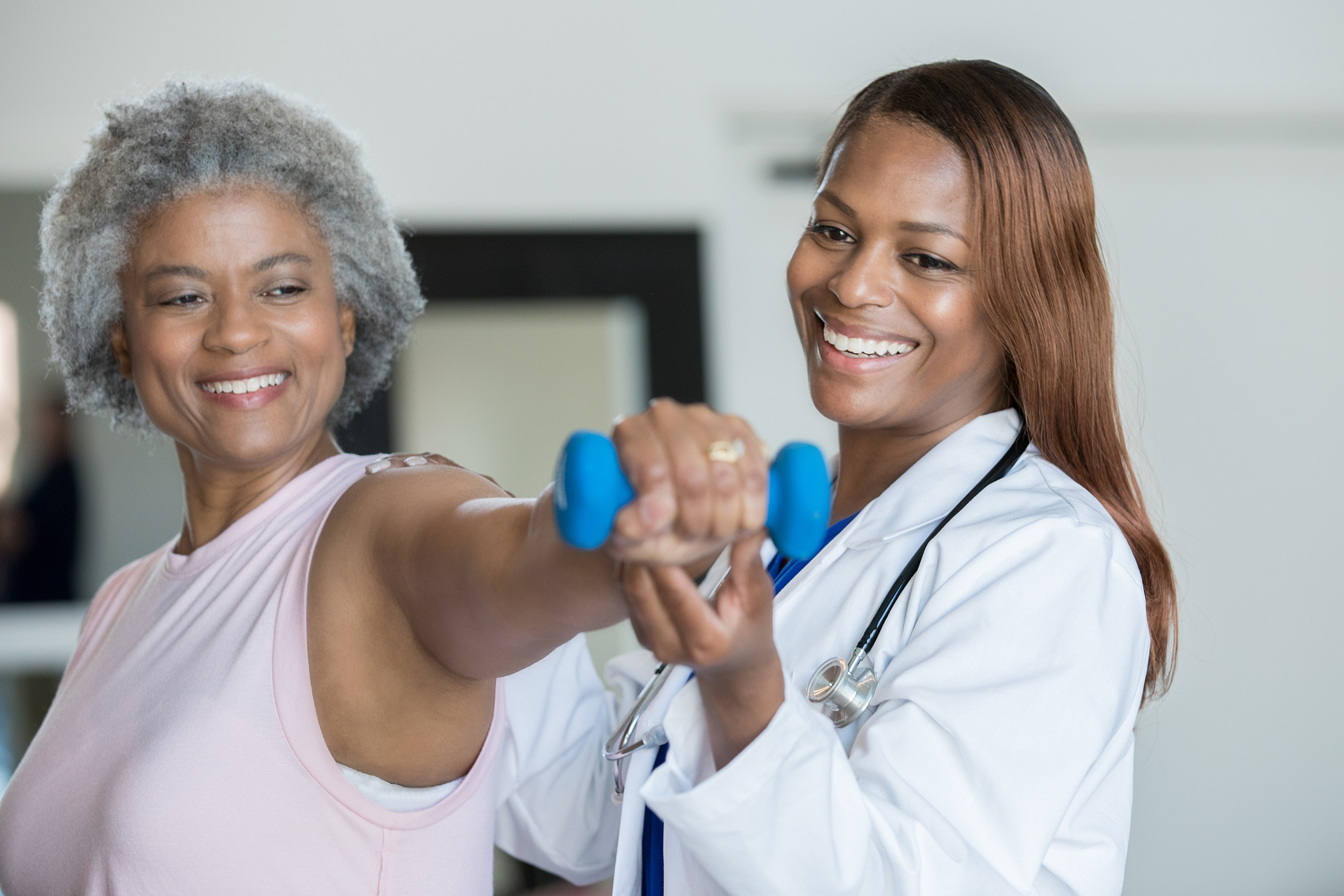 senior woman working on wrist strength at physical therapy