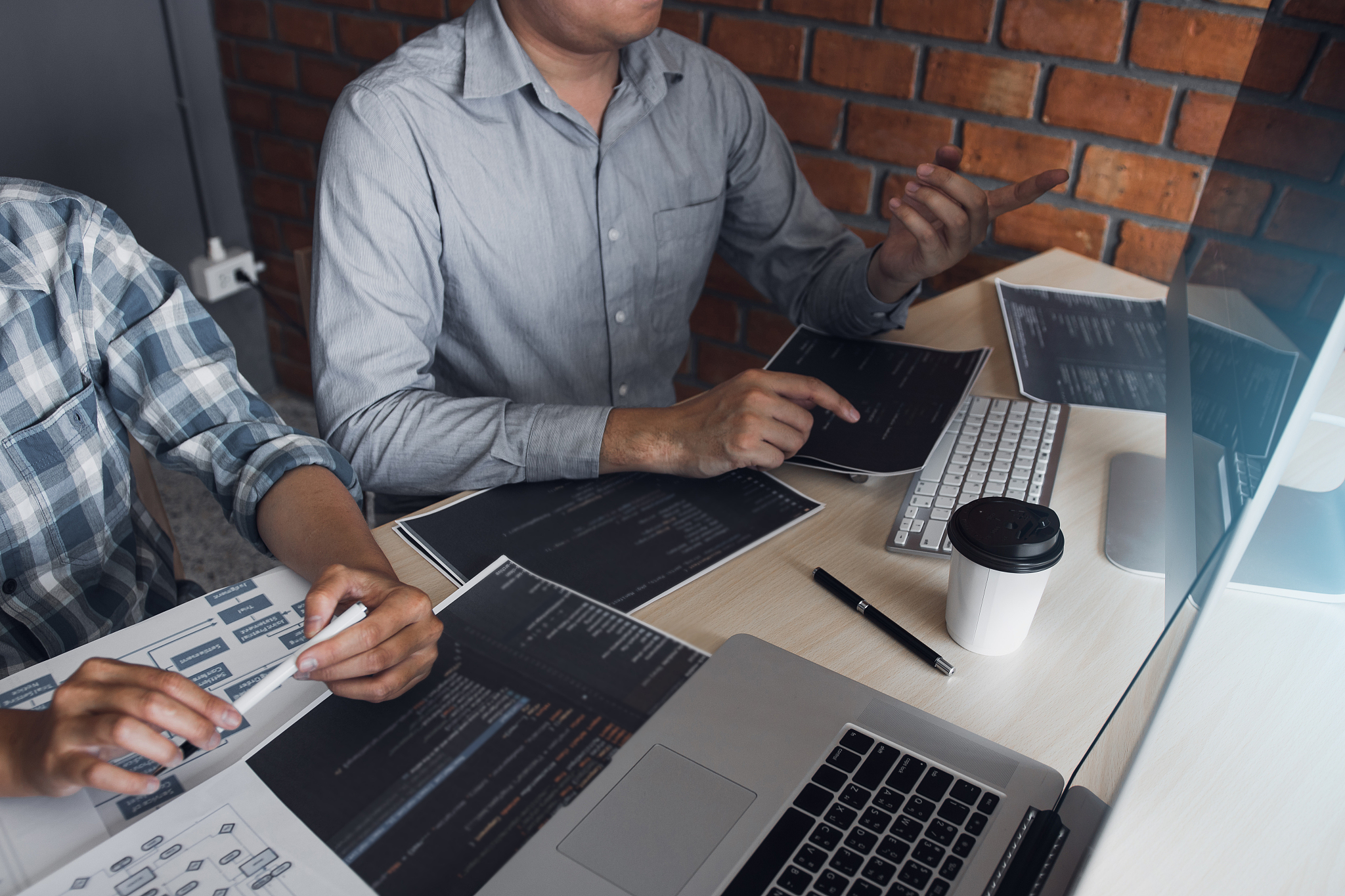 two software developers are using computers to work together wit