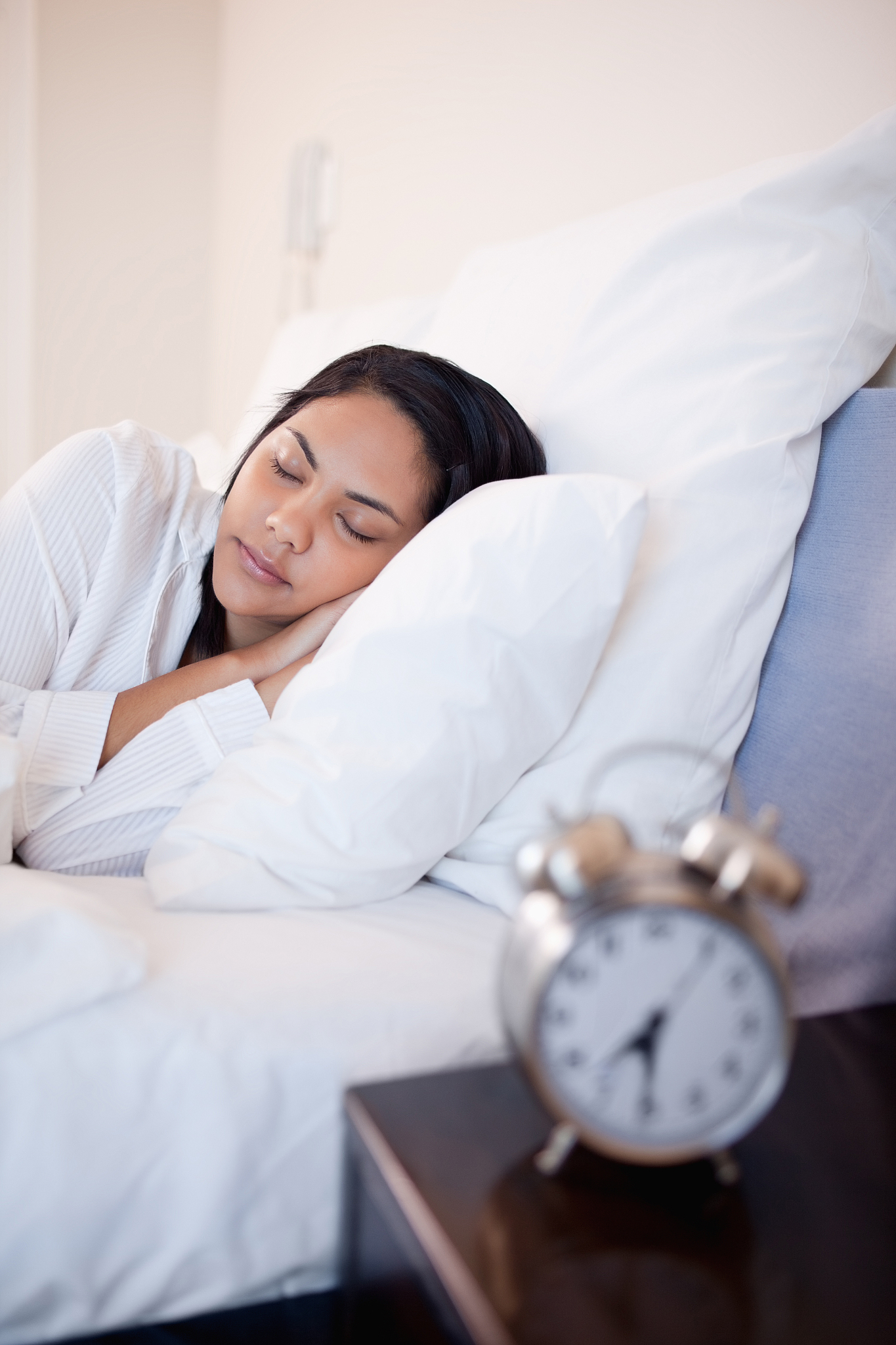 side view of woman sleeping in her bed
