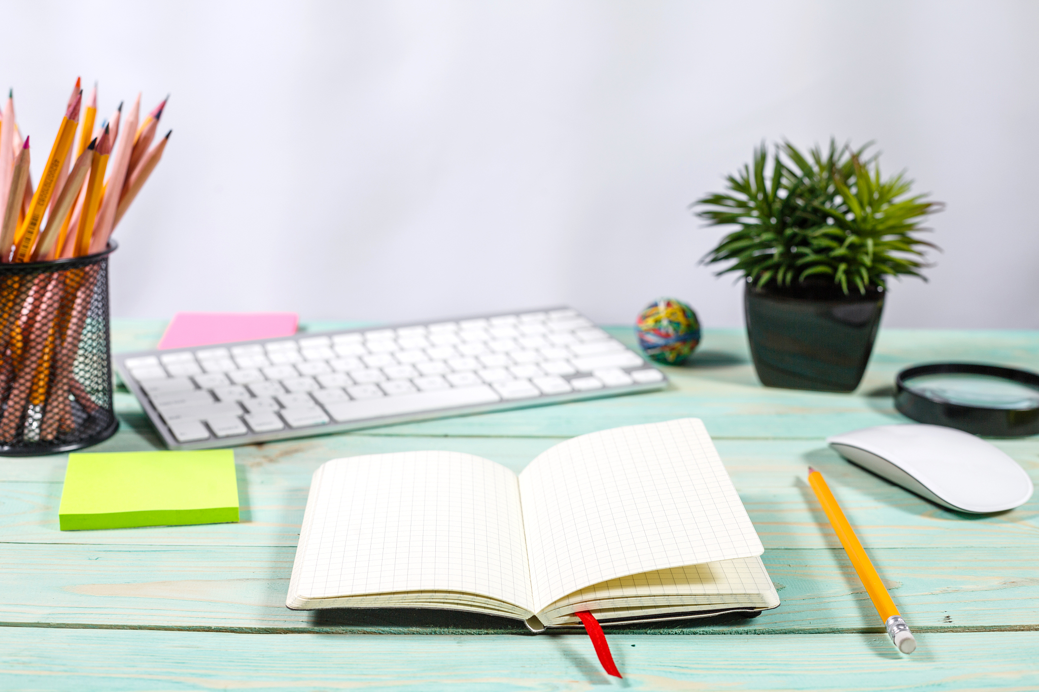 office desk table with computer, supplies, flower and coffee cup