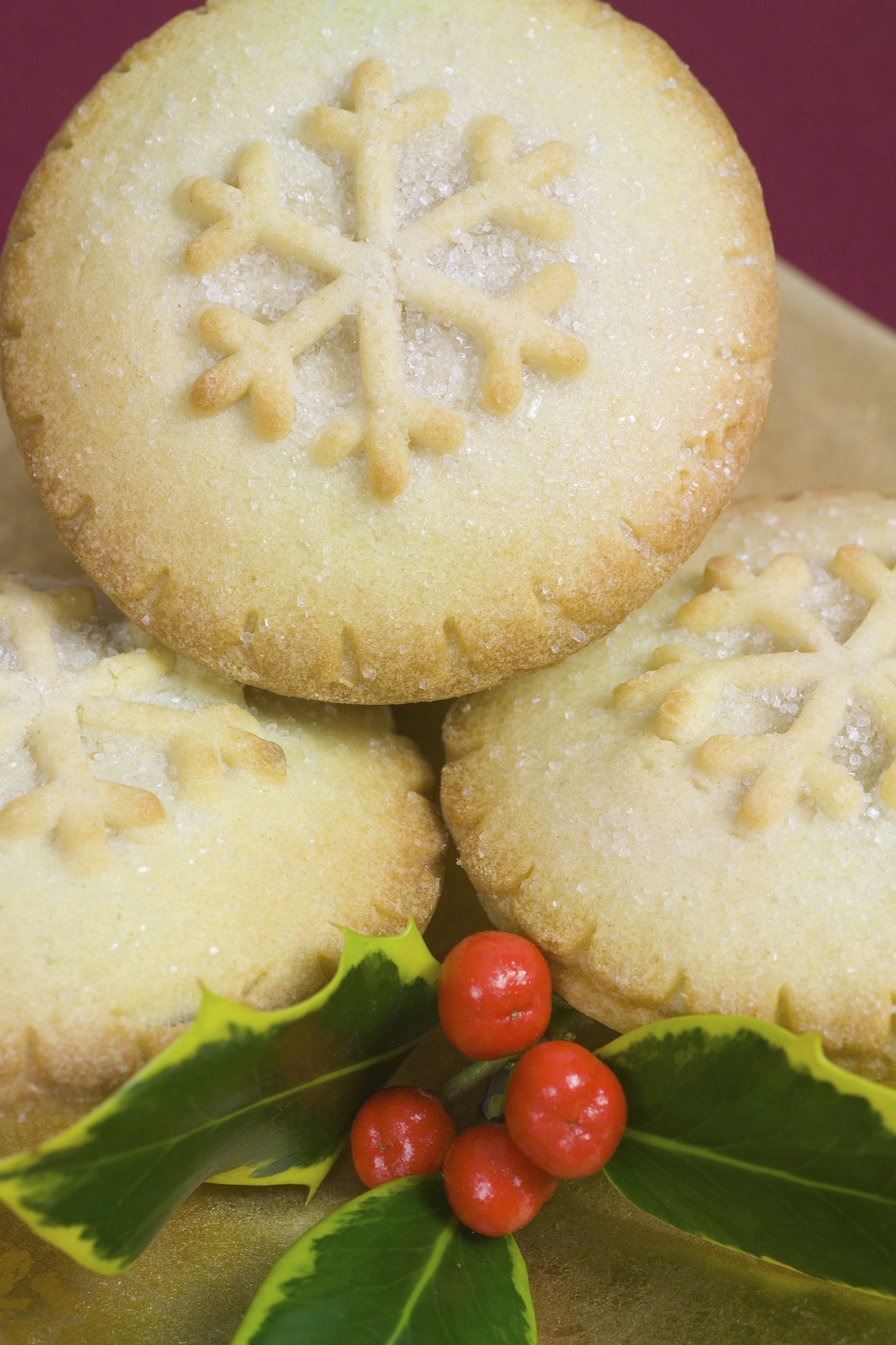 christmas mince pies on gold plate with holly