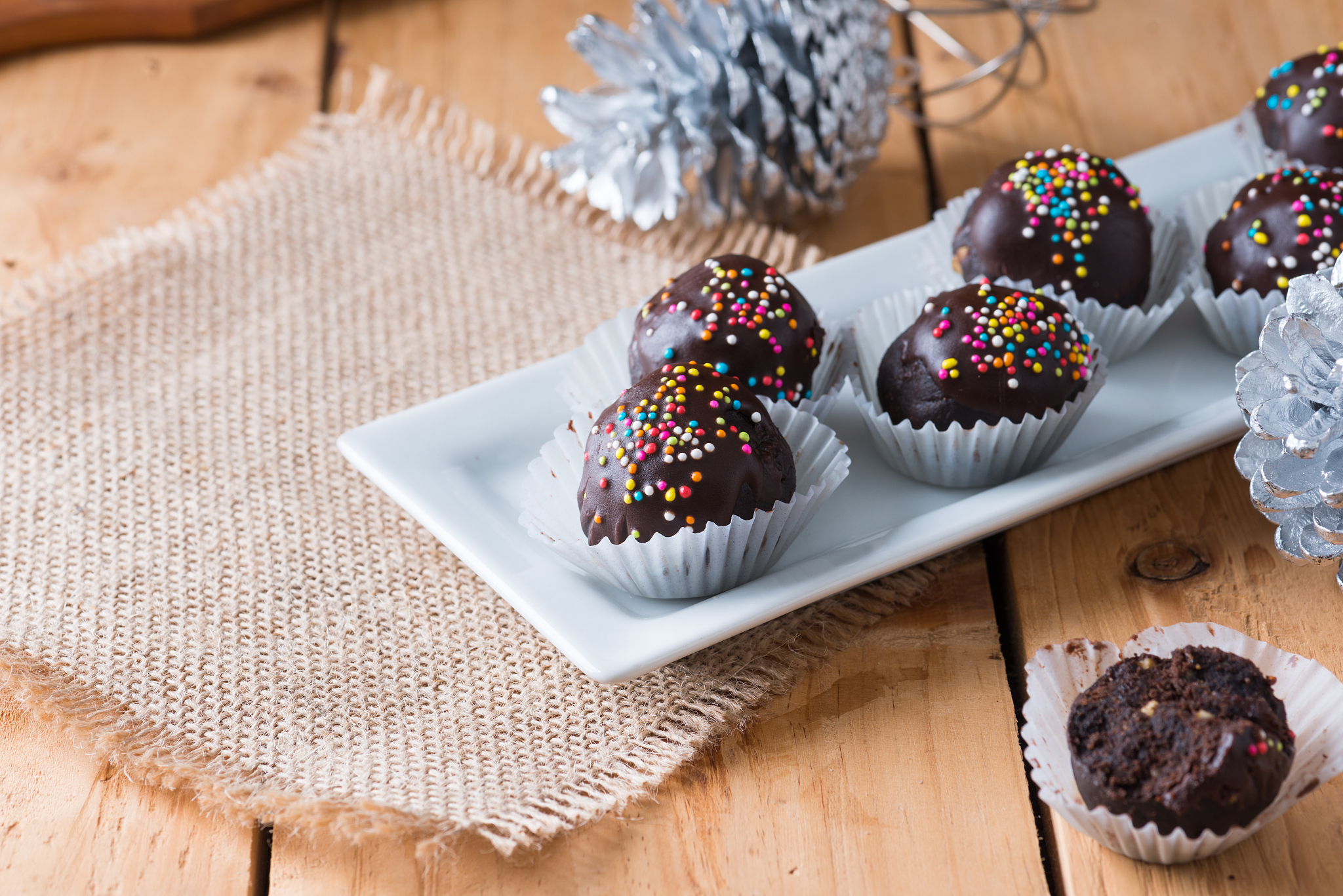 colorful chocolate sprinkles on tasty round chocolate coated cak