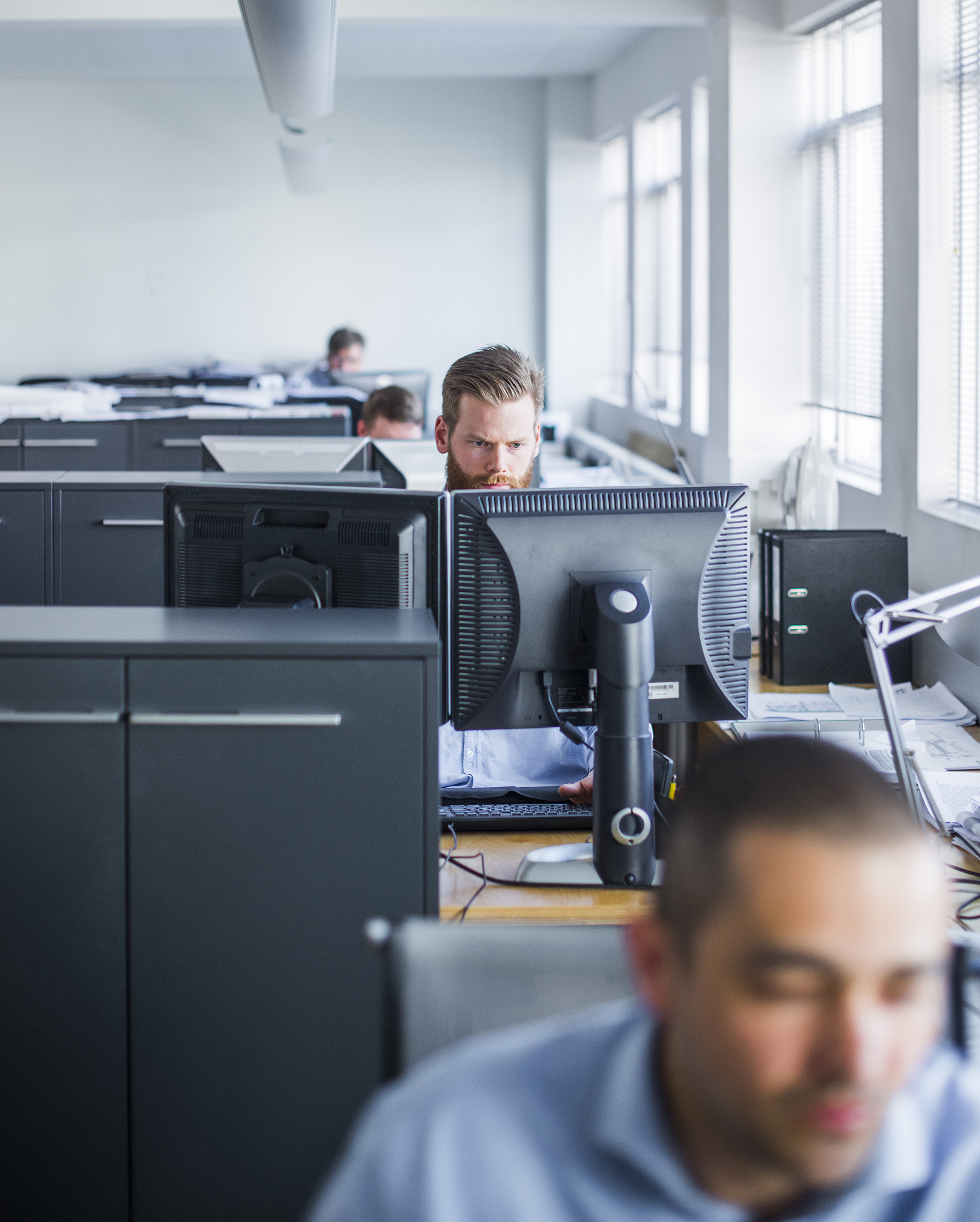 young businessman using computer at office desk