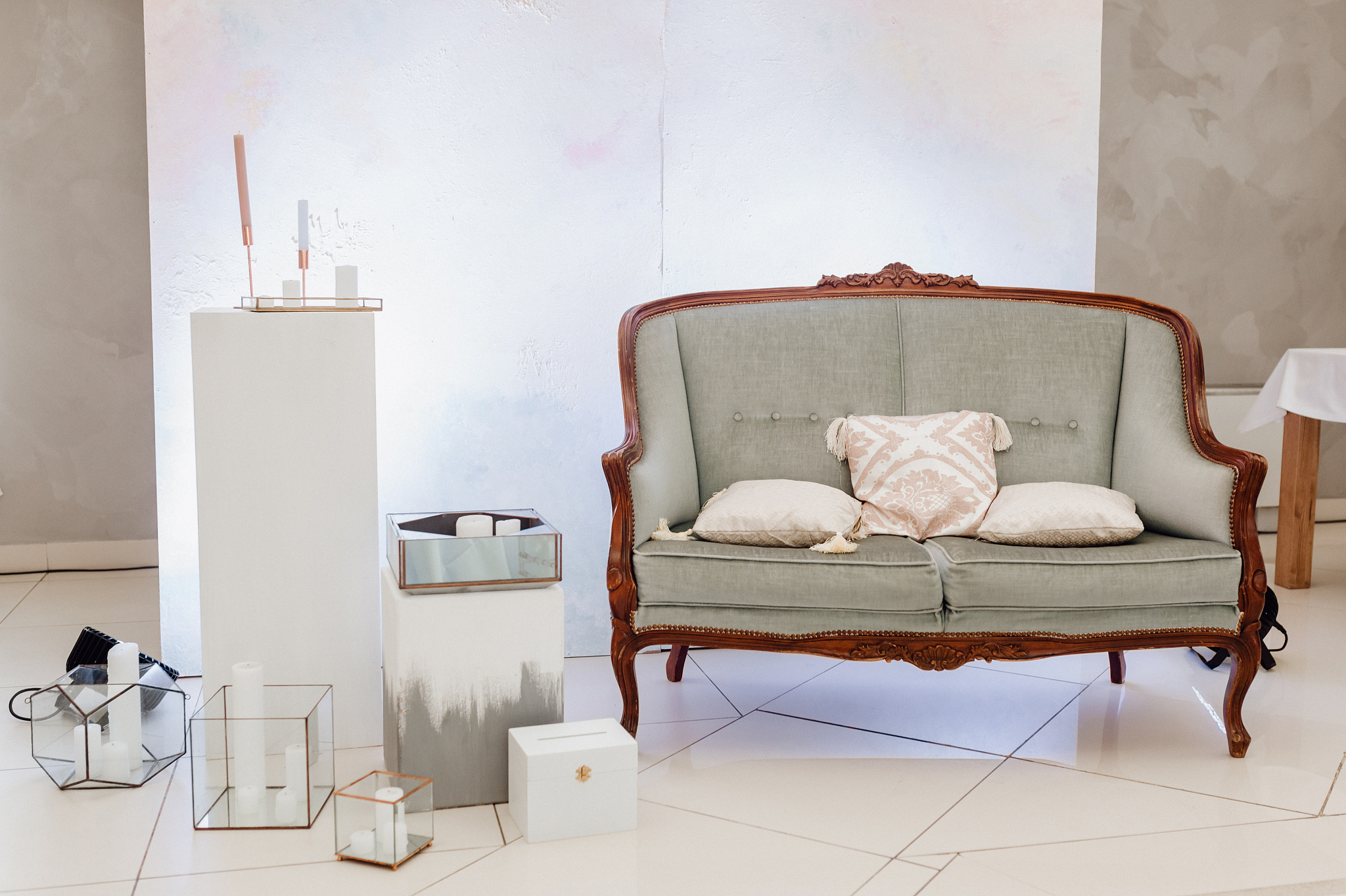 vintage sofa with pillows and candles in glass box