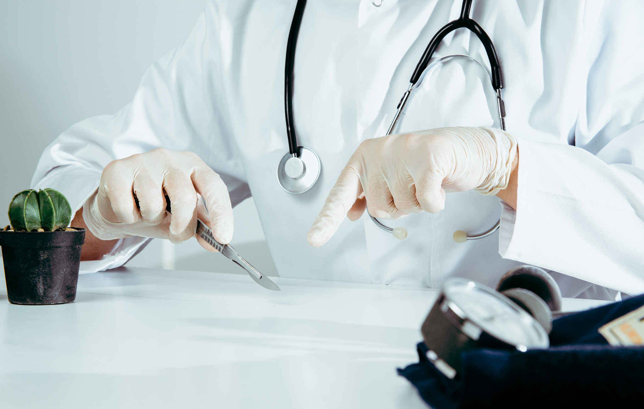 the doctor holds a scalpel in his hand. medical and pharmaceutic