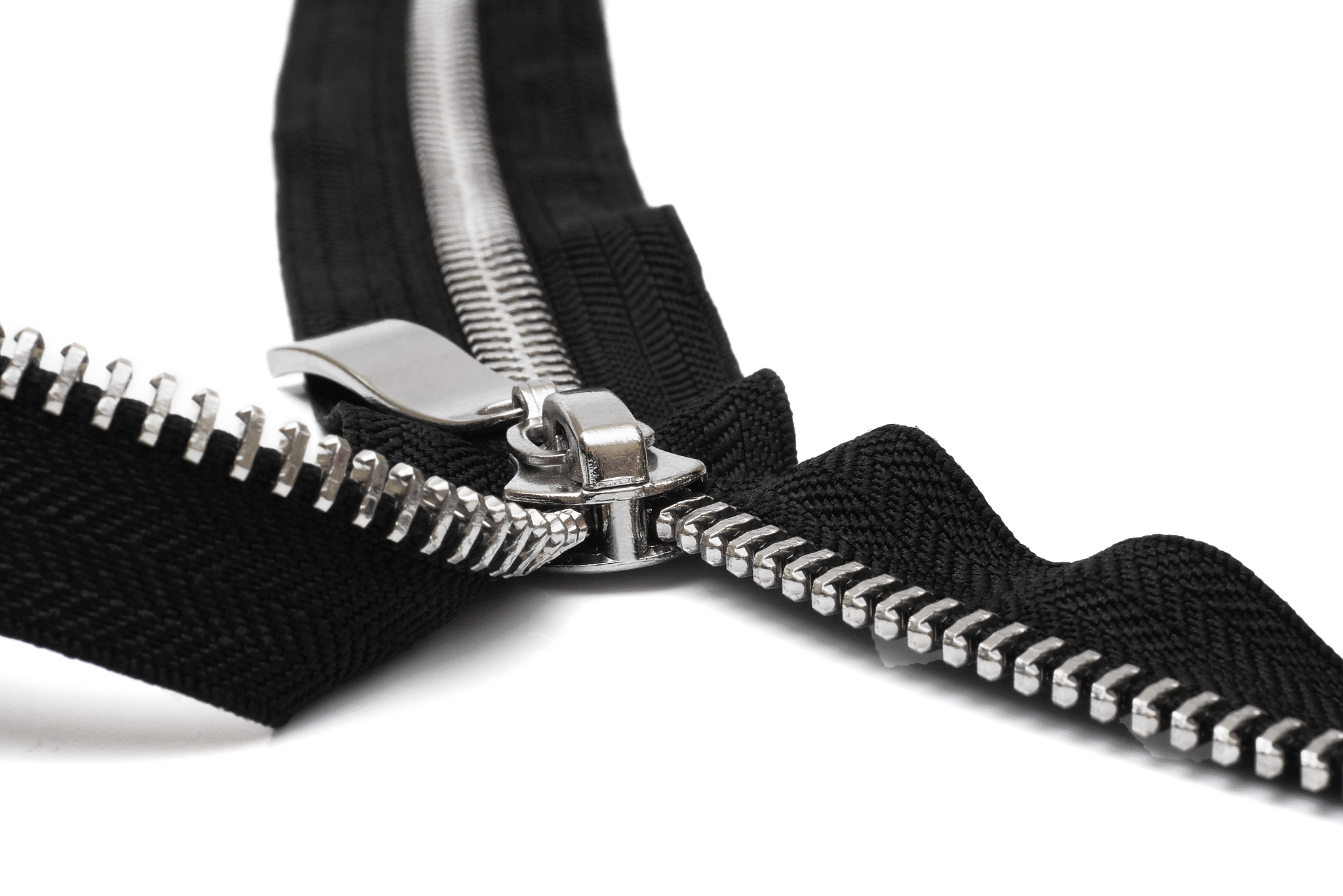 macro of open metal zipper with black fabric isolated on white b