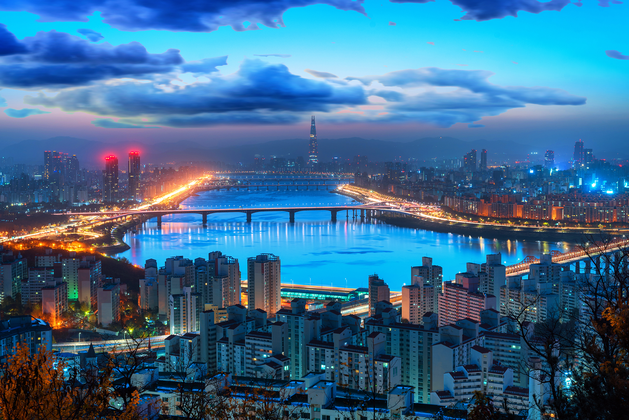 high angle view of illuminated city buildings against sky