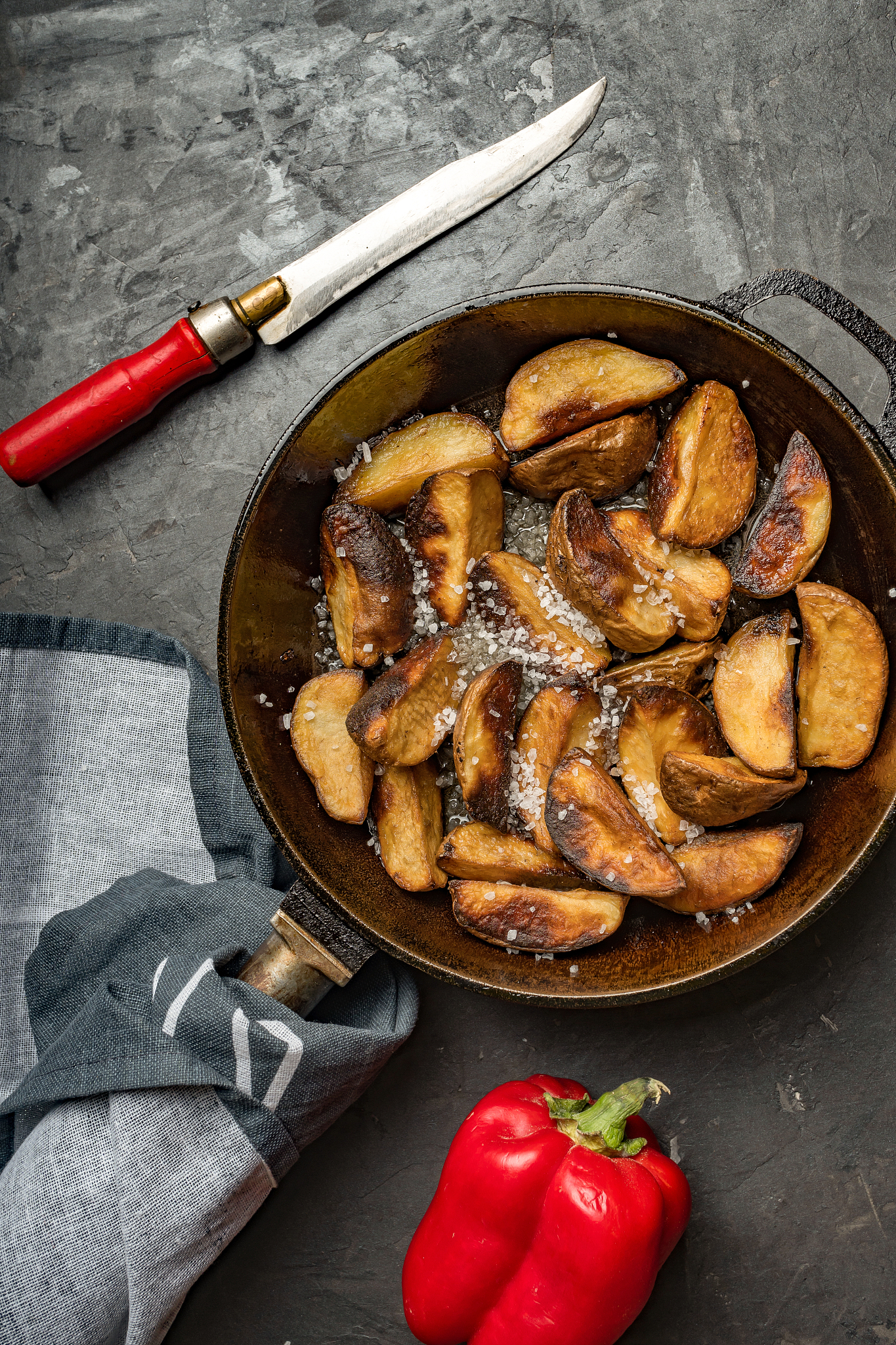 sweet potatoes, baked chicken, potato wedges, iron pan, dark bac