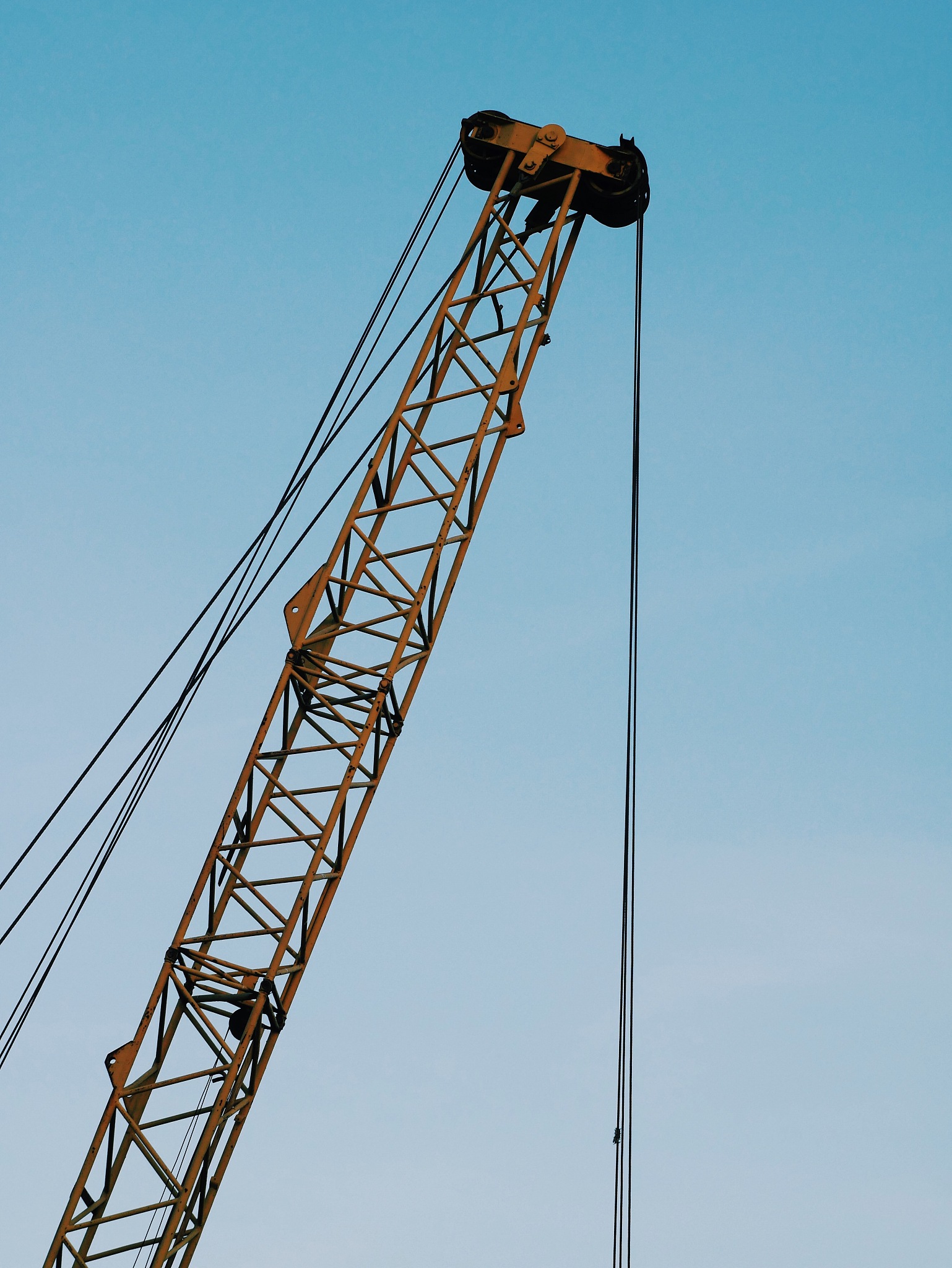 low angle view of crane against clear blue sky