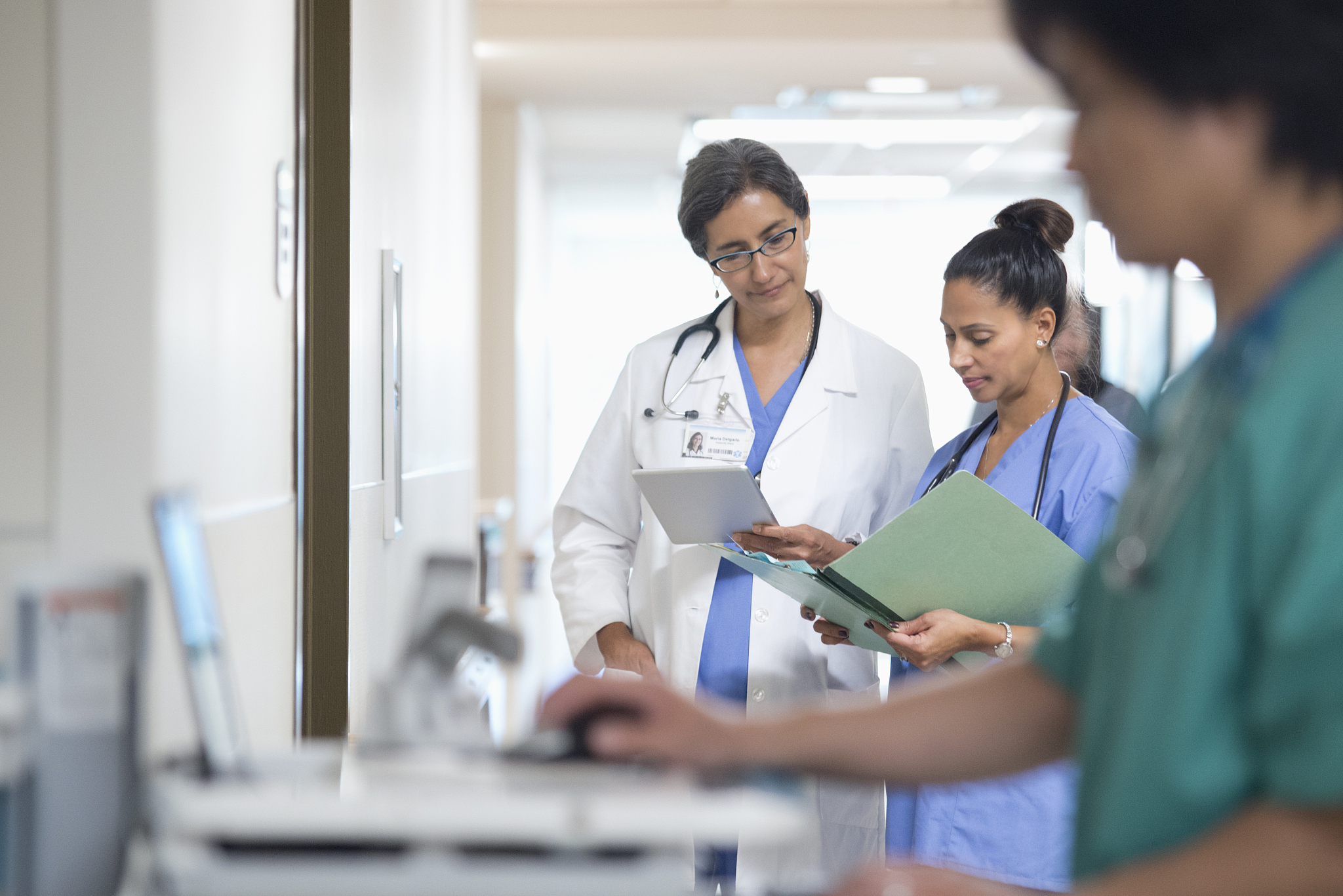 doctors discussing exam results in hospital corridor