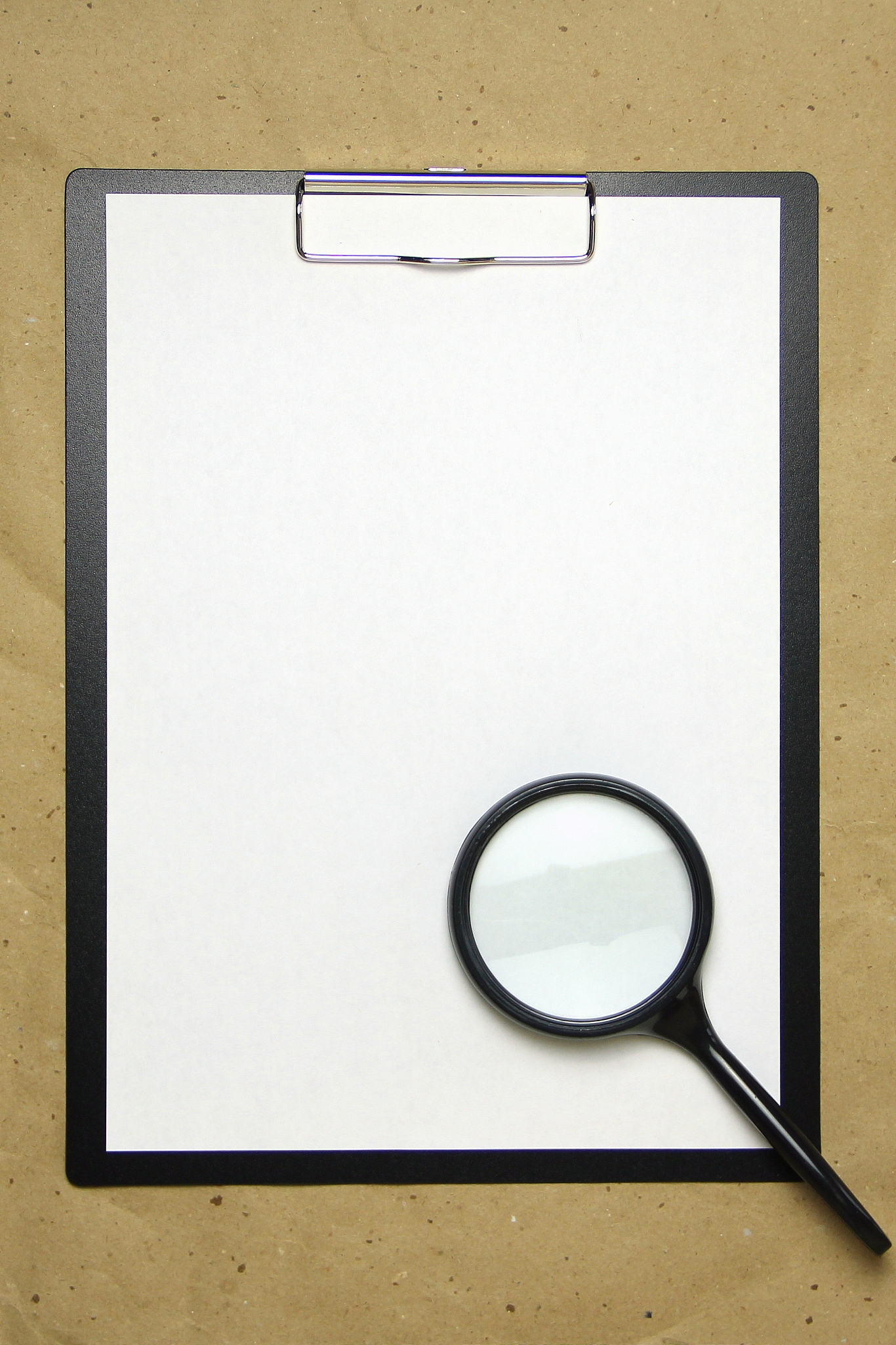 a tablet with a white sheet of a4 format on a beige craft paper