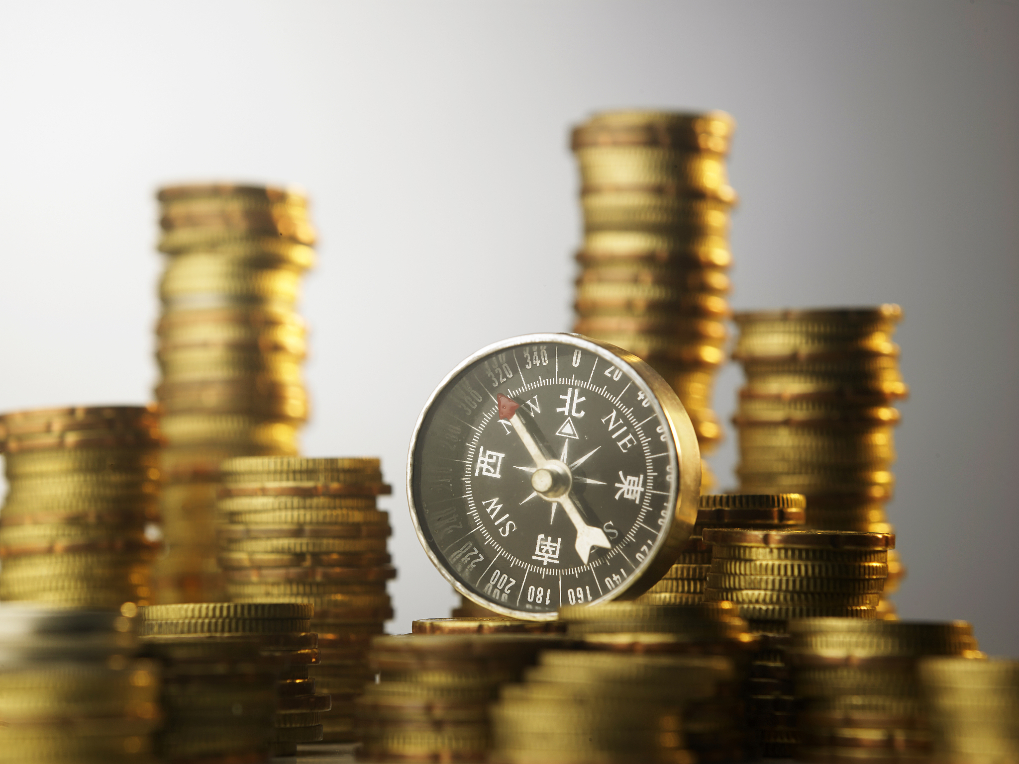 compass on many stacks of coins
