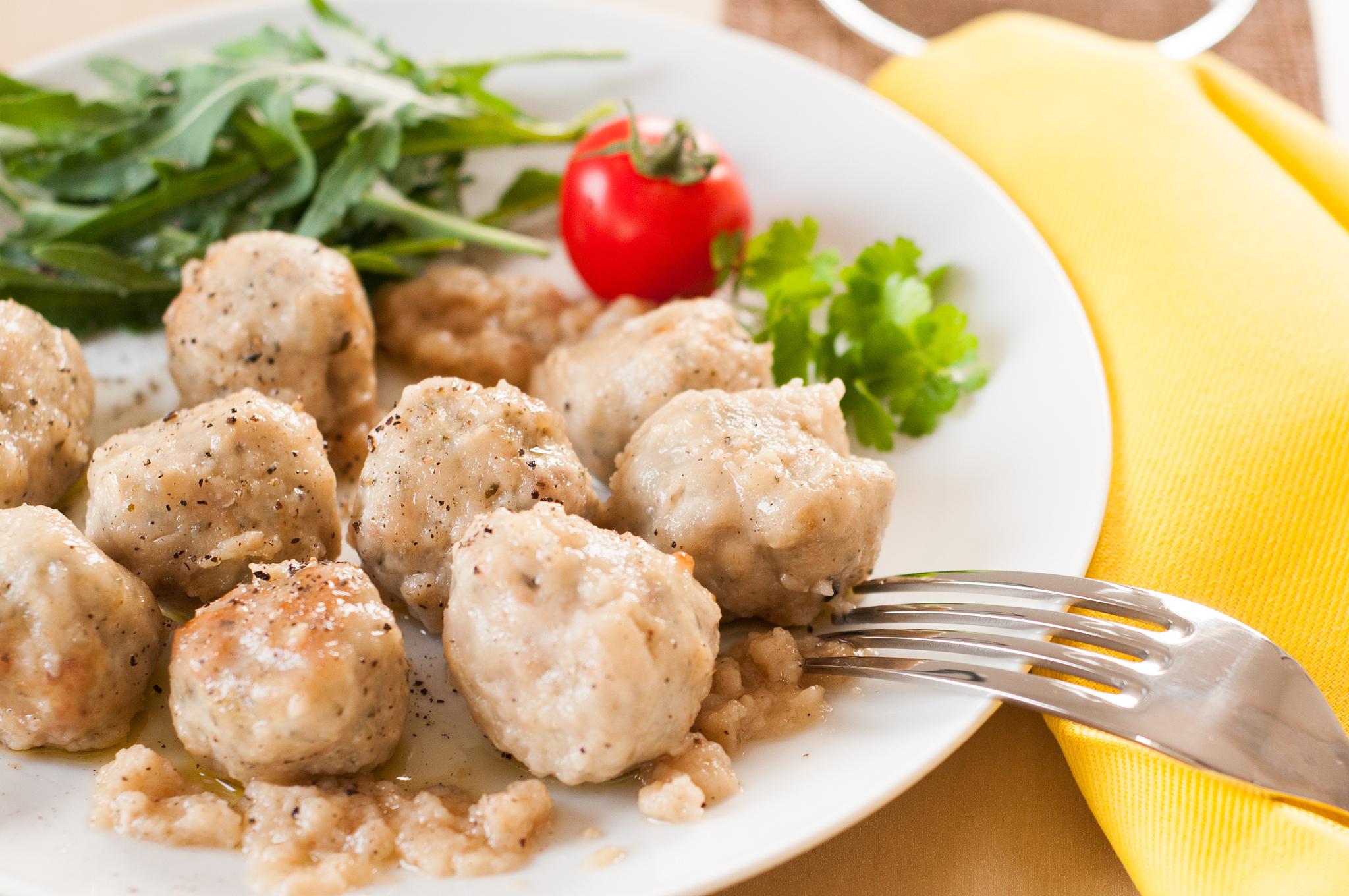 meatballs with parsley and a cherry tomato