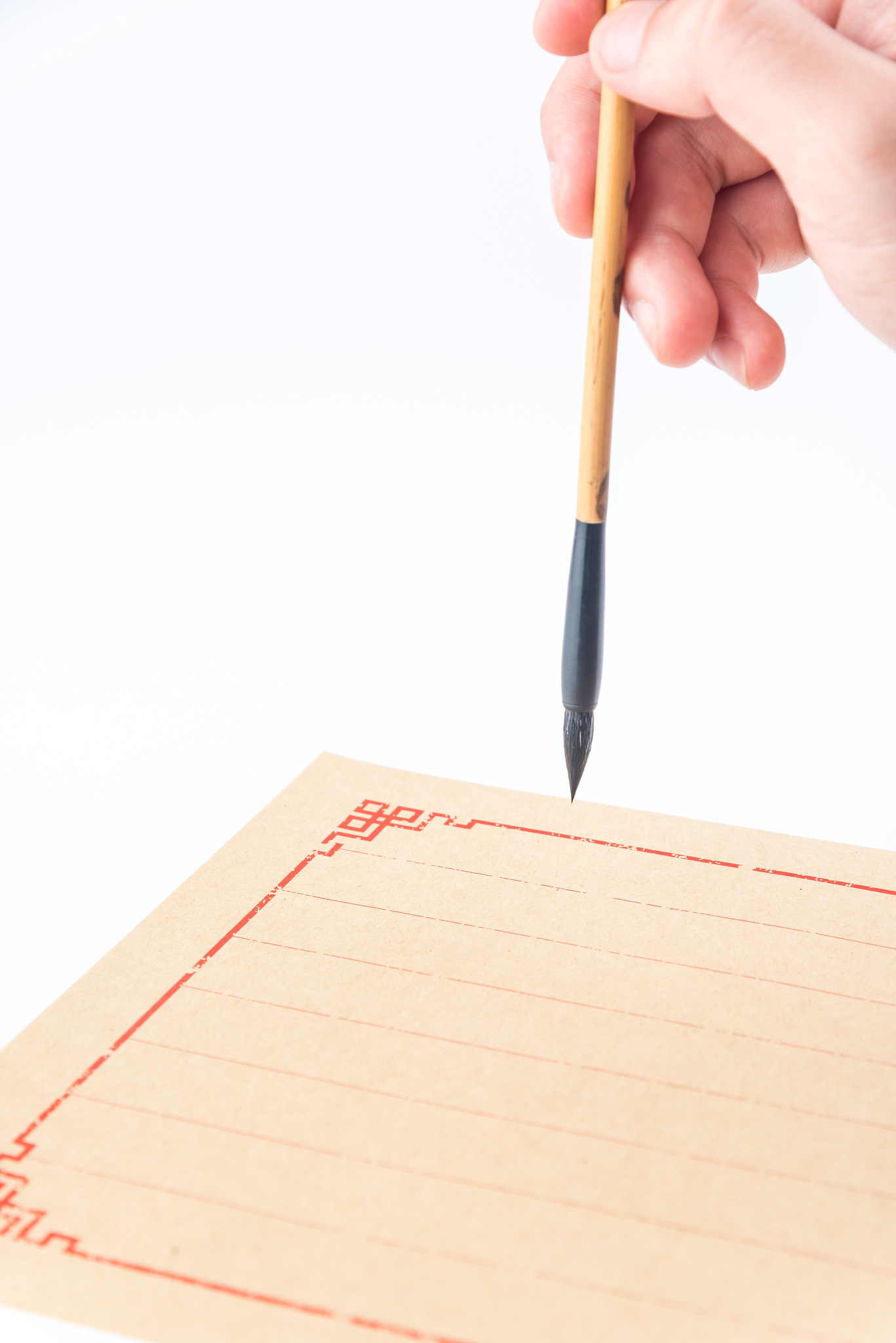 chinese brush in hand and writing on letter