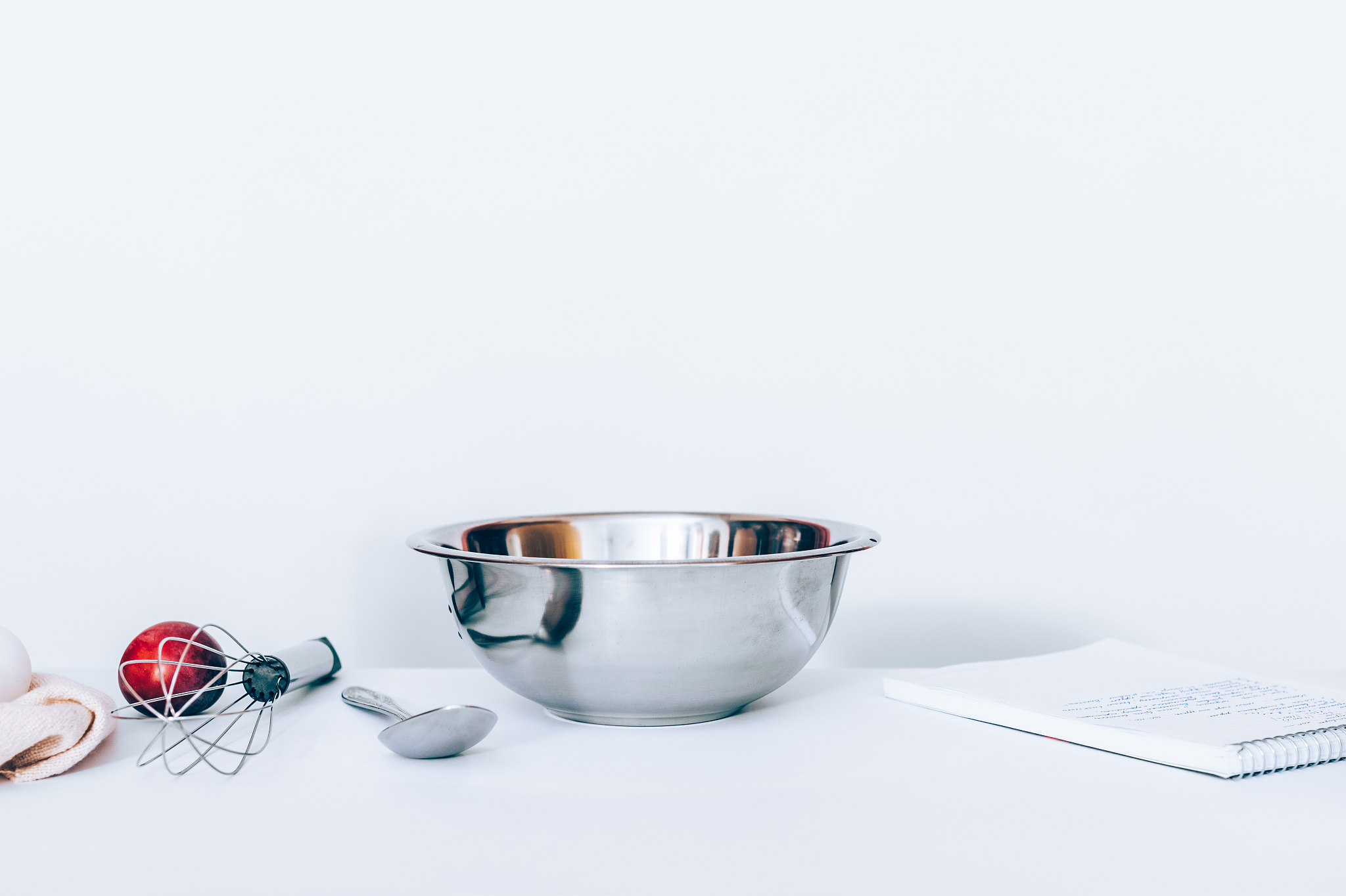 baking concept: metal stainless bowl in the center of the white 