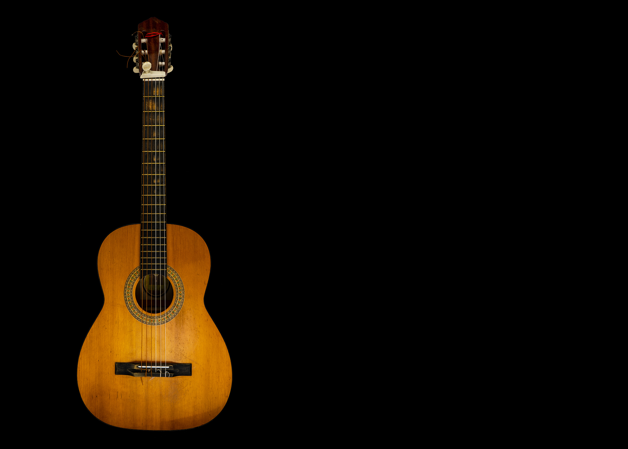 guitar with six strings on black background