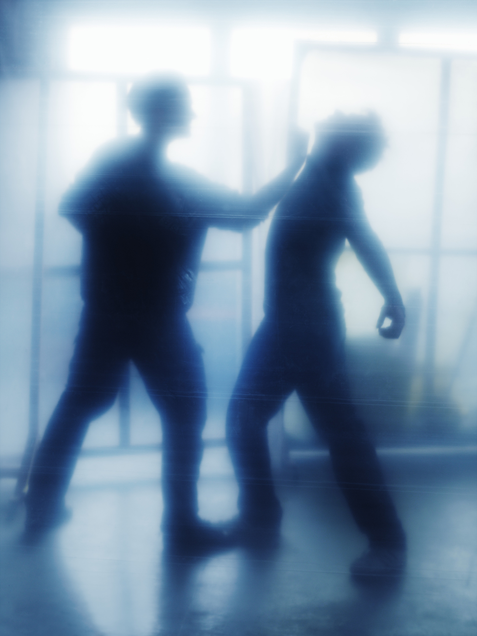 man punching man on chin, side view