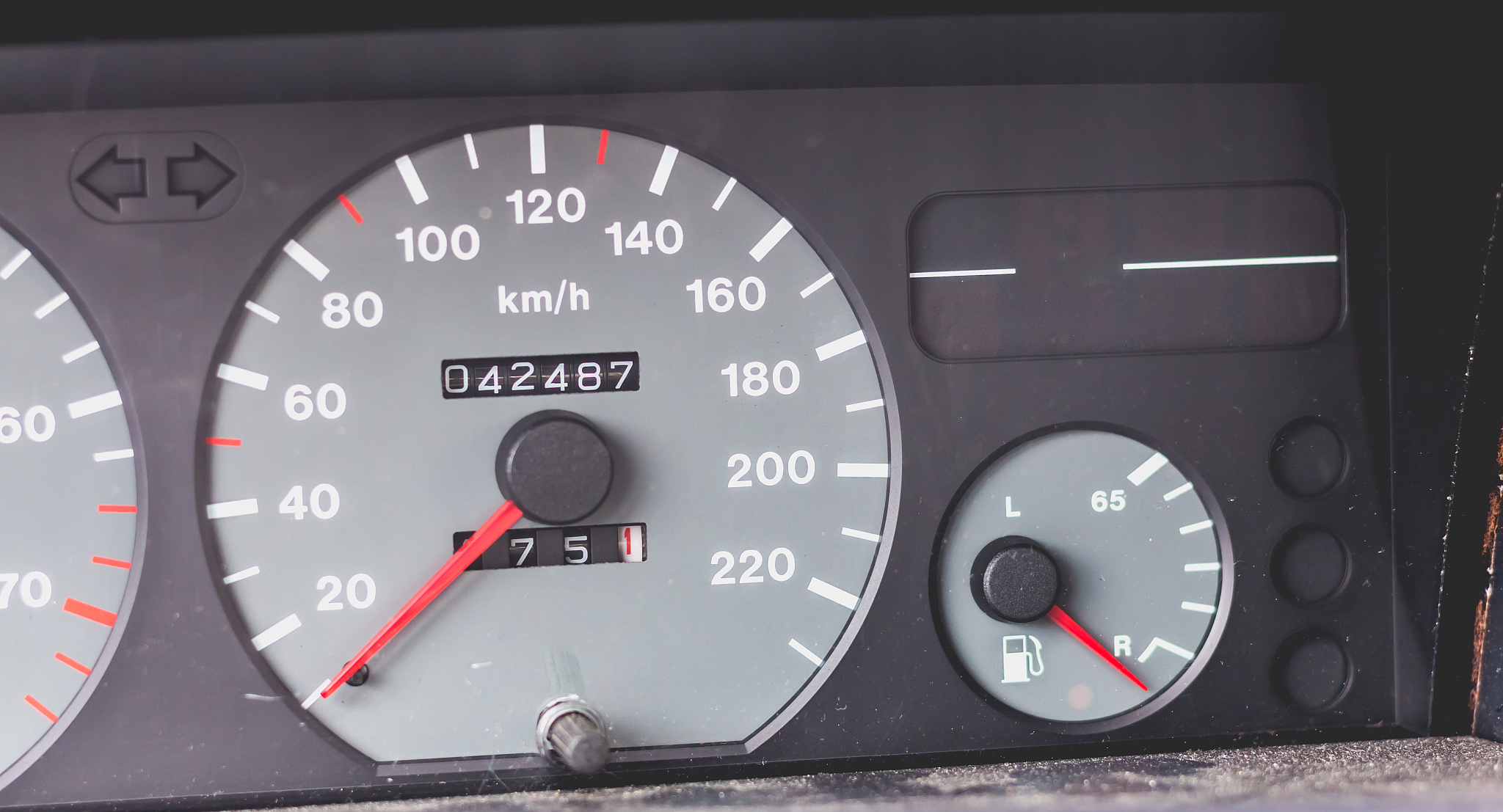 old car dashboard of the 90's with speedometer, tachometer...