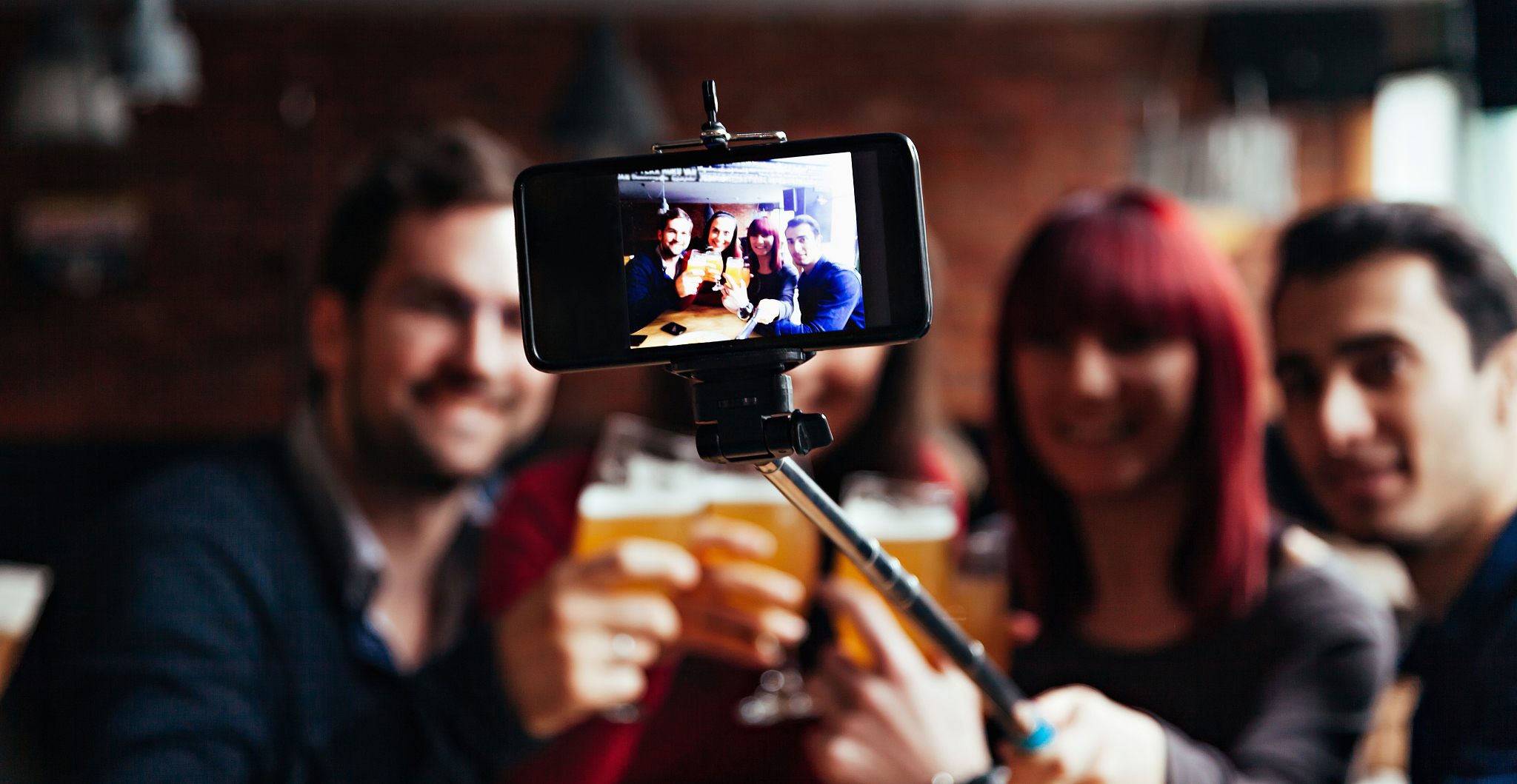 a group of friends in a tavern taking a selfie