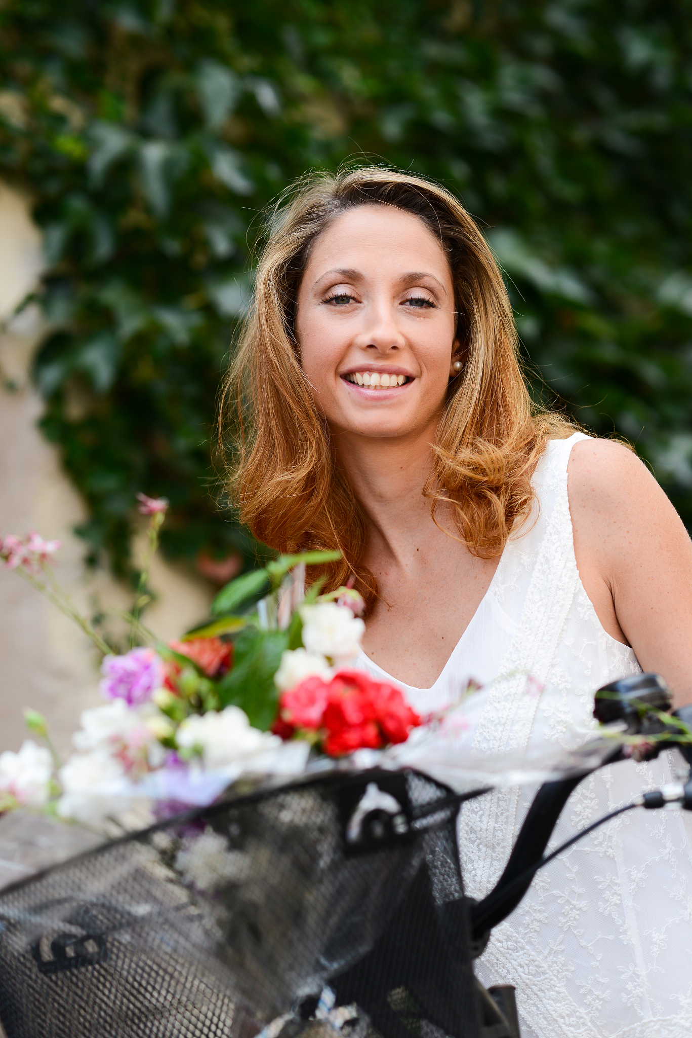 cheerful and attractive young woman riding bicycle in summertime