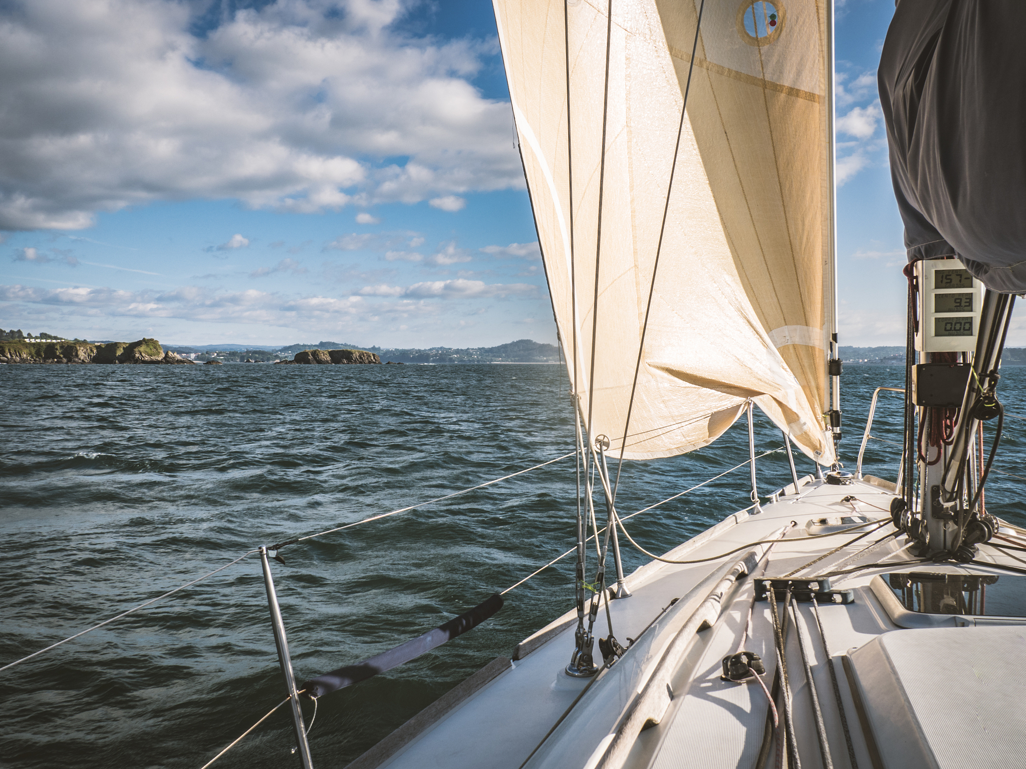 sailboat in the sea near the coastline