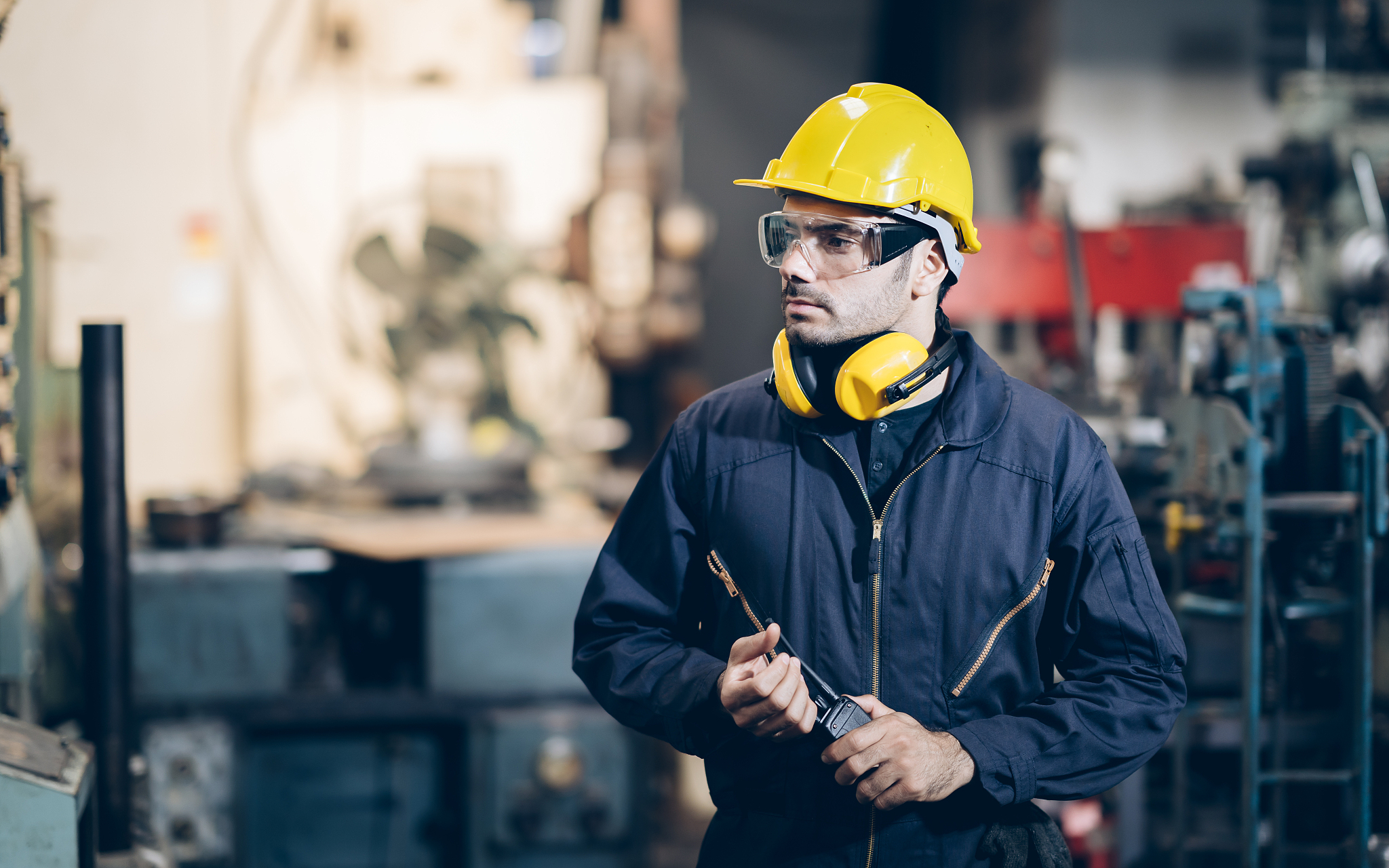 technician engineer man command to portable radio in factory