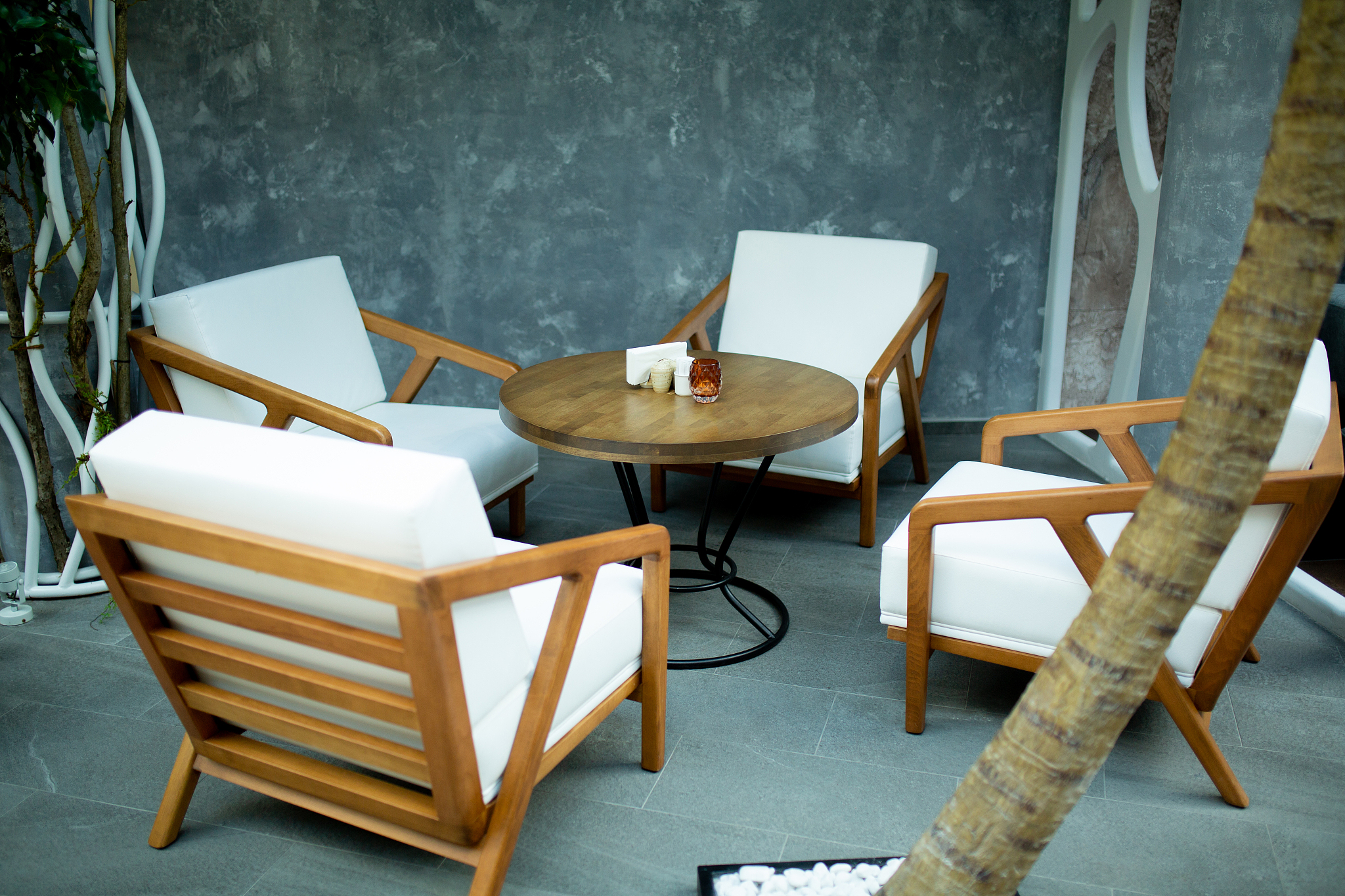a cozy place to meet with a round table, white chairs