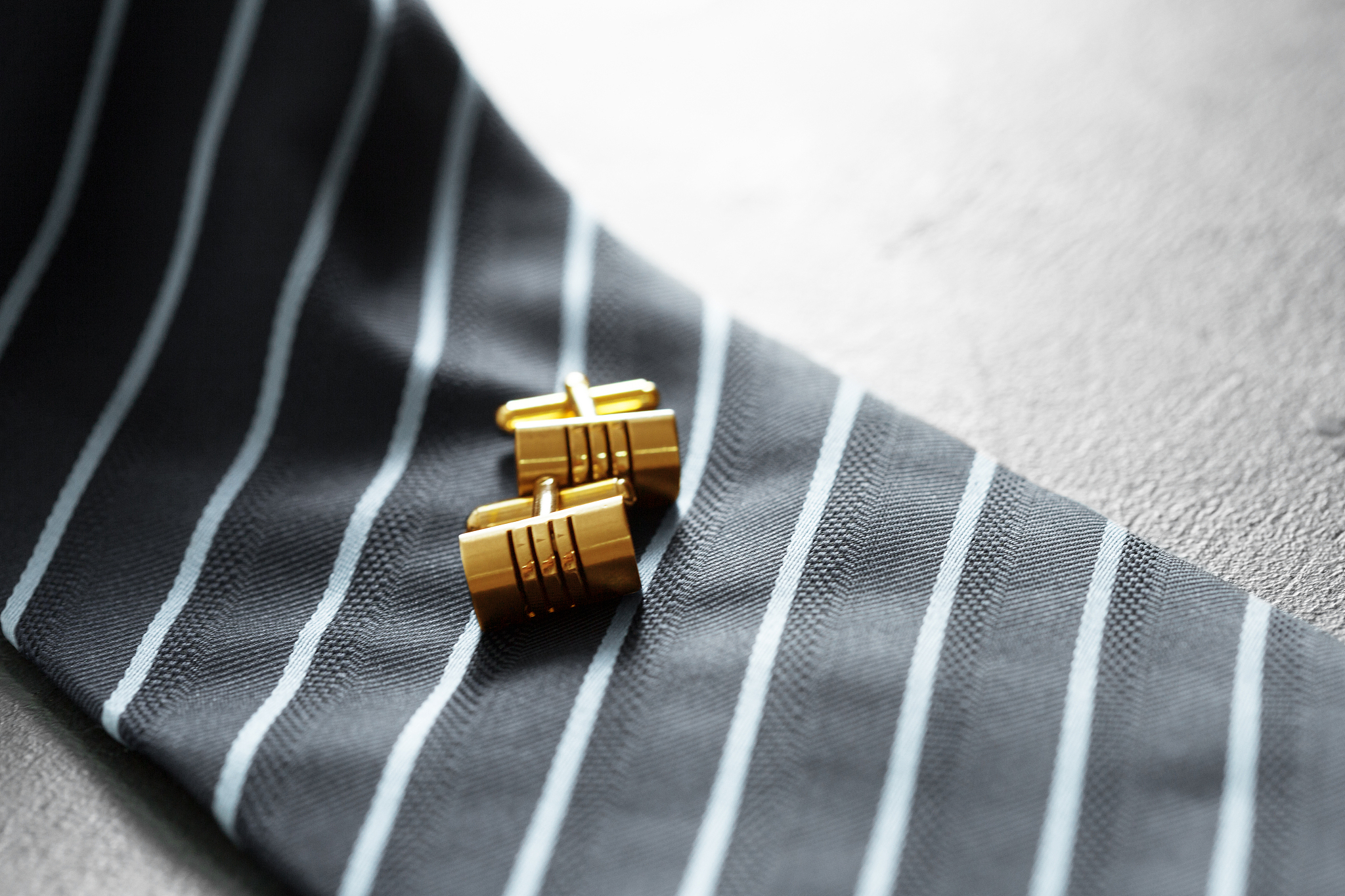 tie and cufflinks on the table .