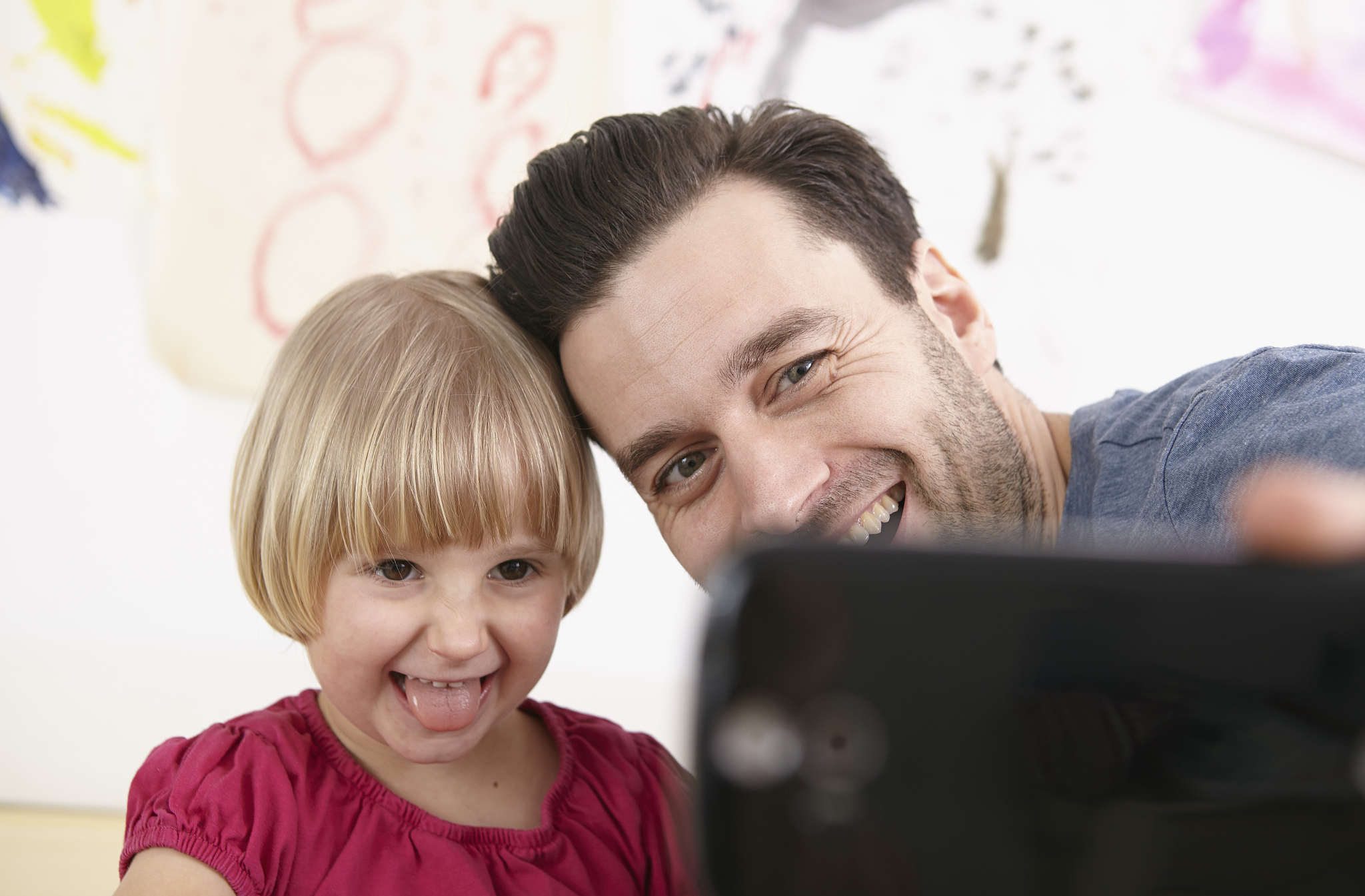 father and daughter taking selfie with smart phone