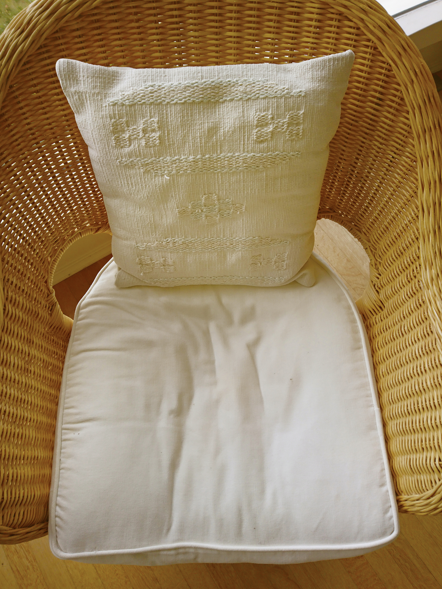 overview of a wicker chair showing signs of recent use with a so