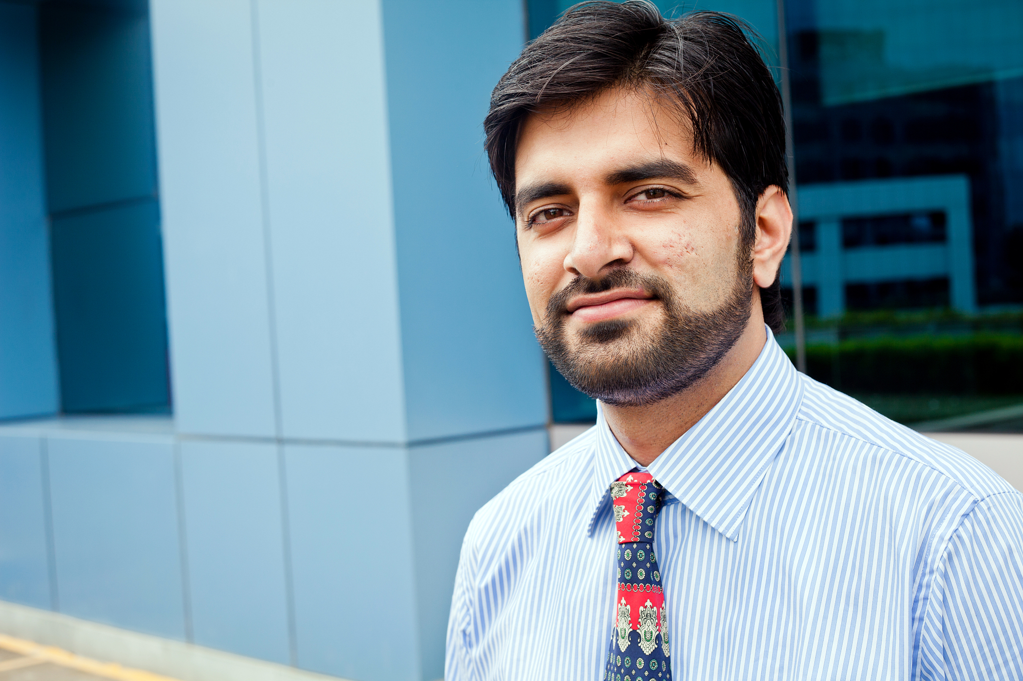 cheerful friendly young indian businessman