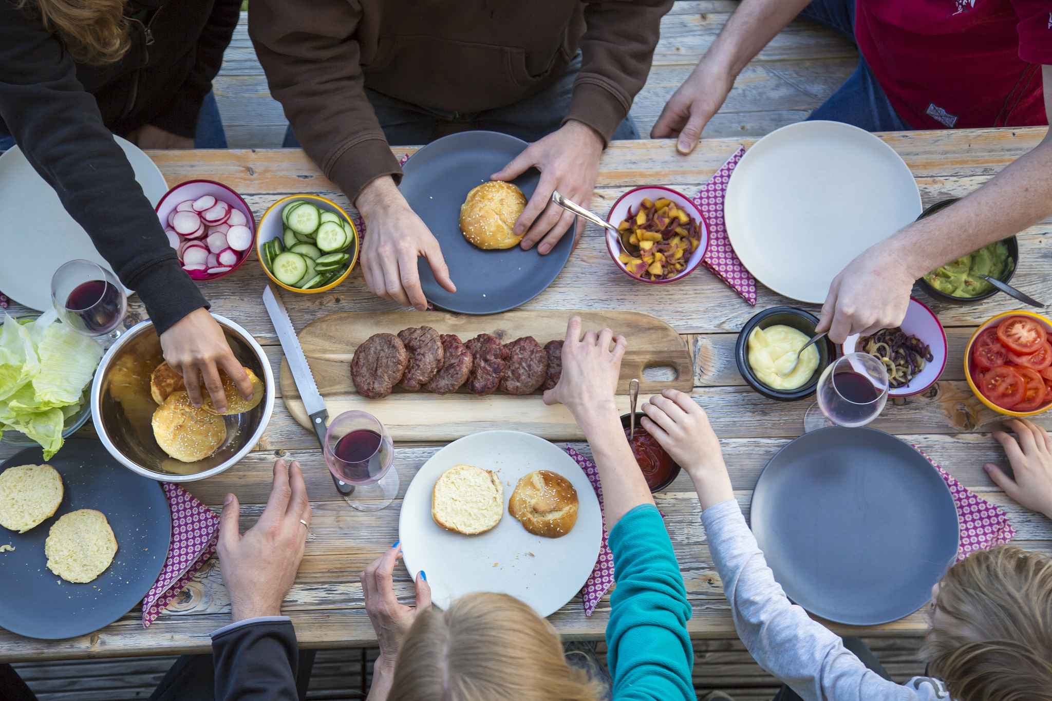 family eating burgers at beer table